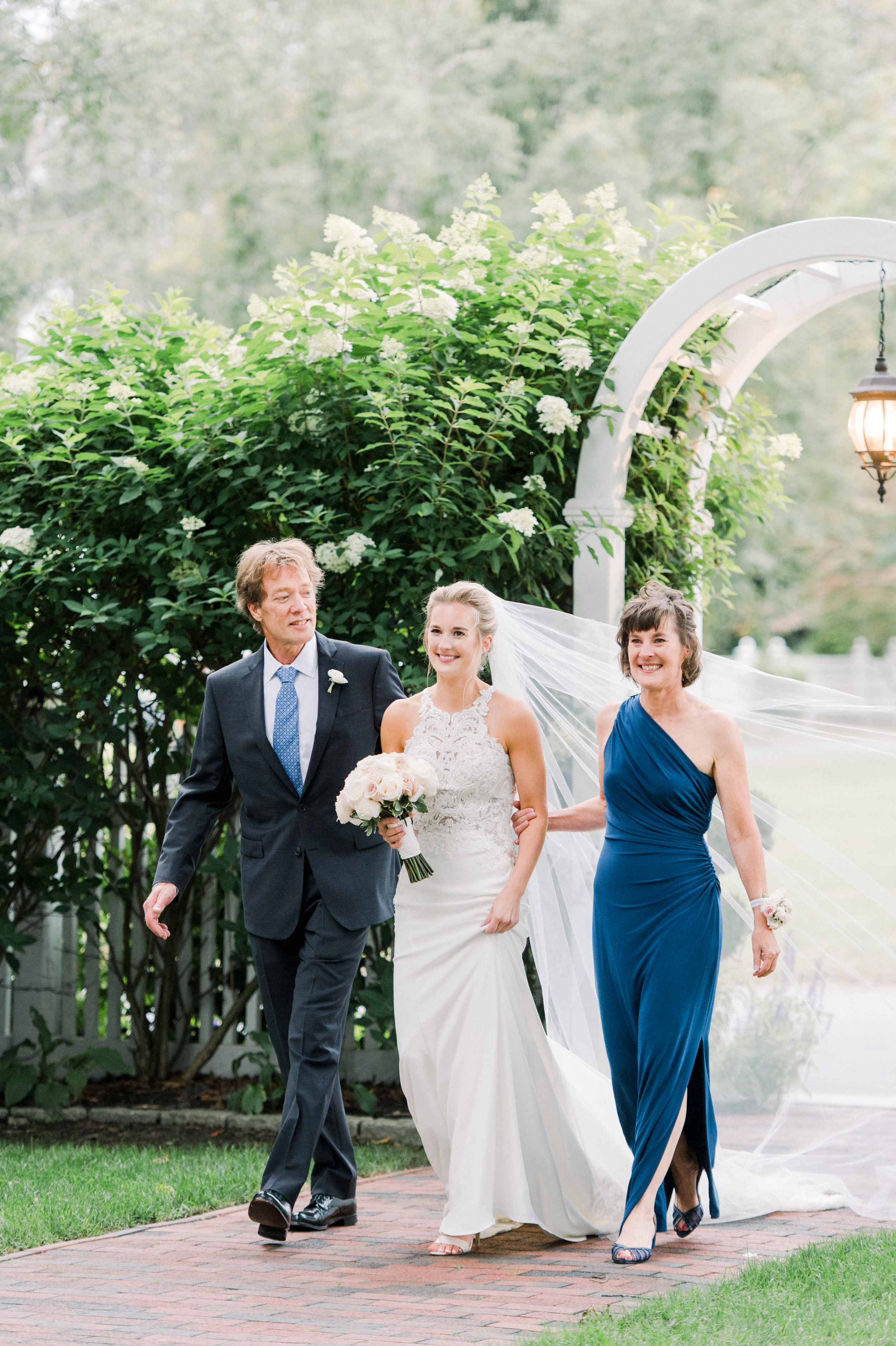 the bride and her parents at a wedding at the commons 1854