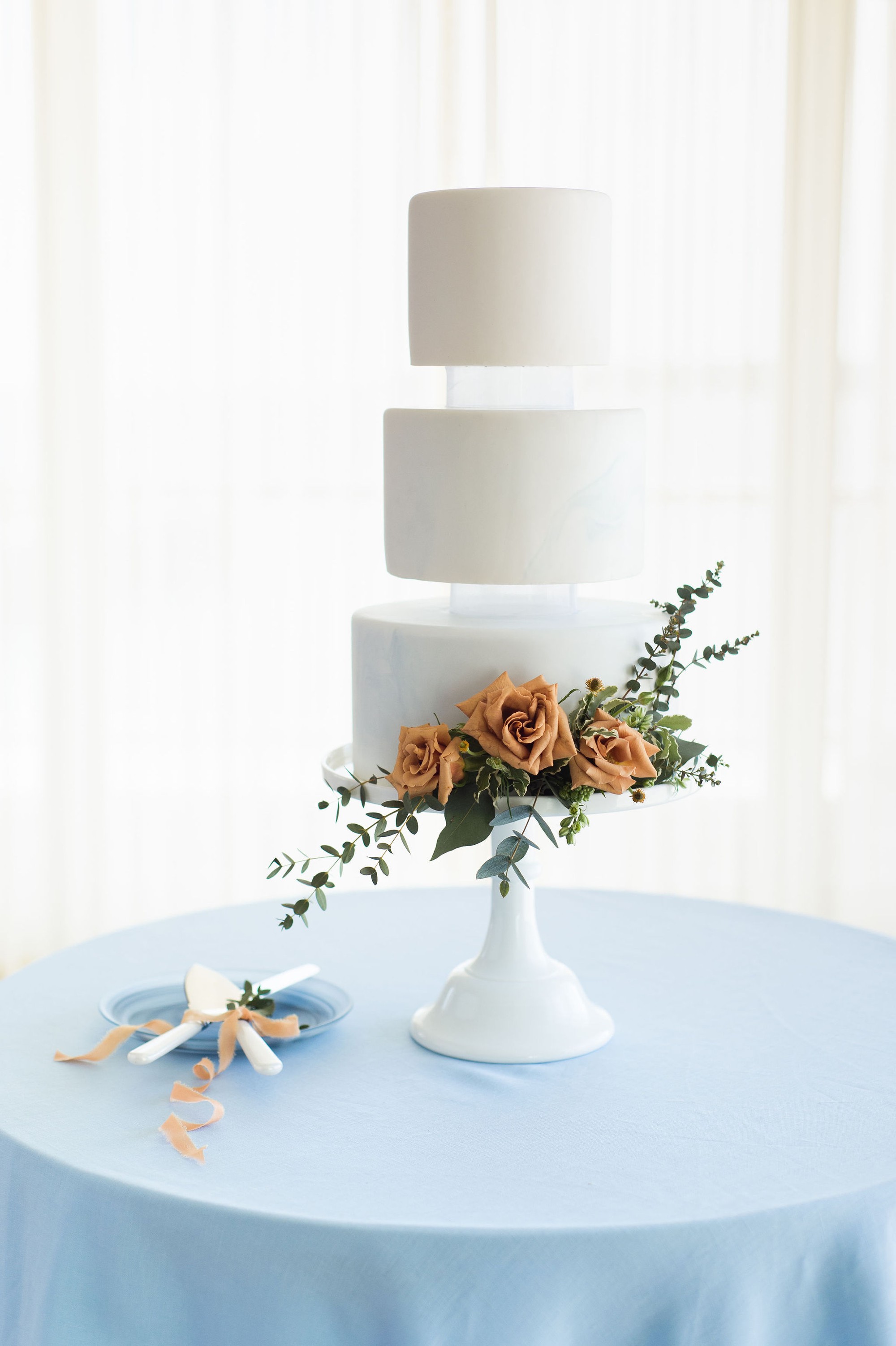 Tuscan meets modern | modern three floating tier wedding cake with pale blue marbling by Silver Whisk Bakery