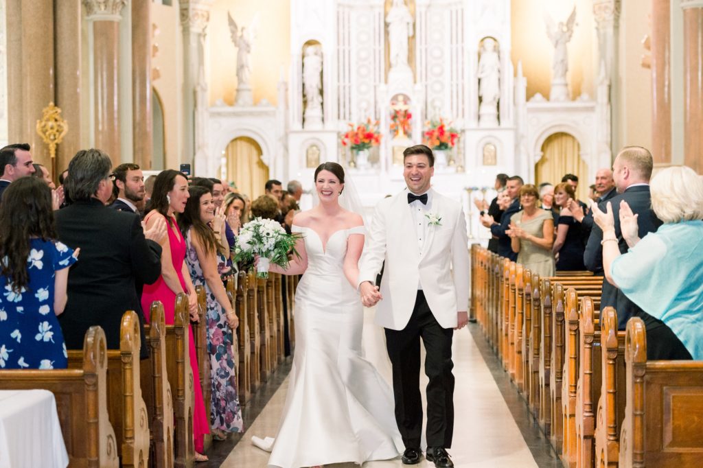 Boston wedding ceremony at Boston's Basilica newlyweds walk down the aisle together