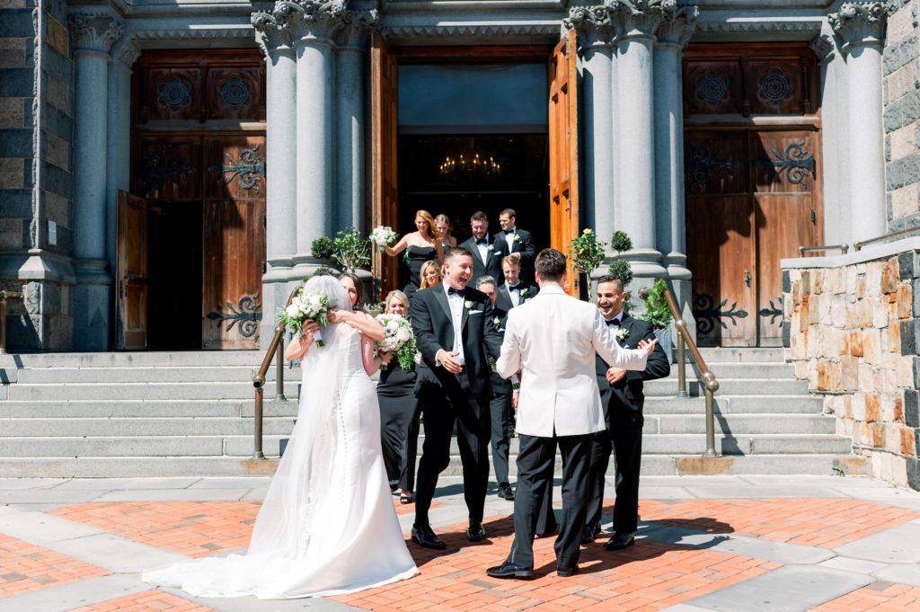 Boston wedding ceremony at Boston's Basilica newlyweds are greeted by bridal party outside the church