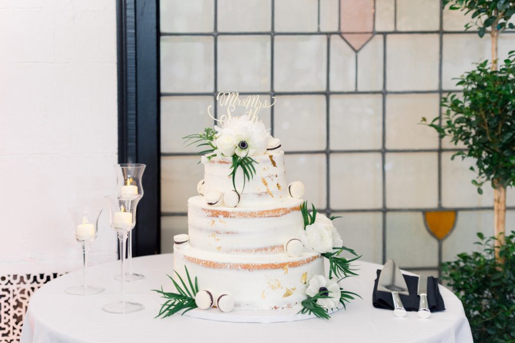 elegant wedding cake with french macarons and white flowers