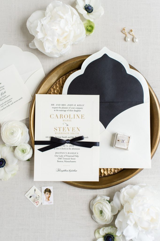 styled bridal flat lay | Black and gold classic invitation suite for alden castle wedding | audrey hepburn vintage stamps