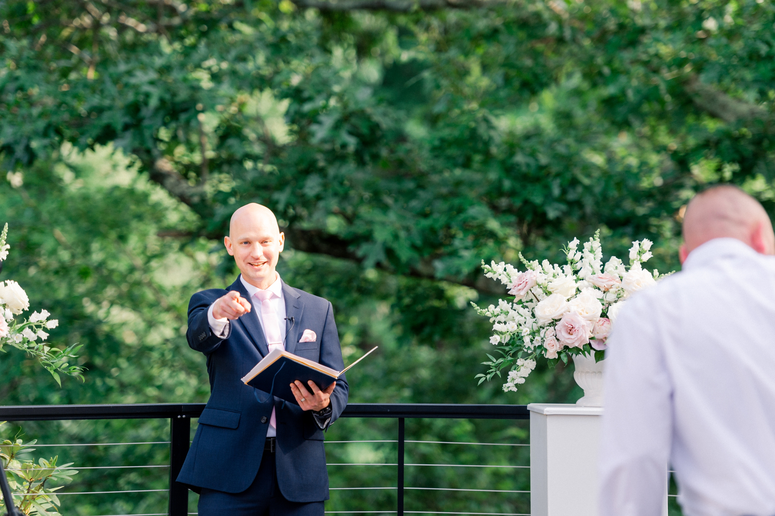 brother of groom officiating outdoor wedding ceremony