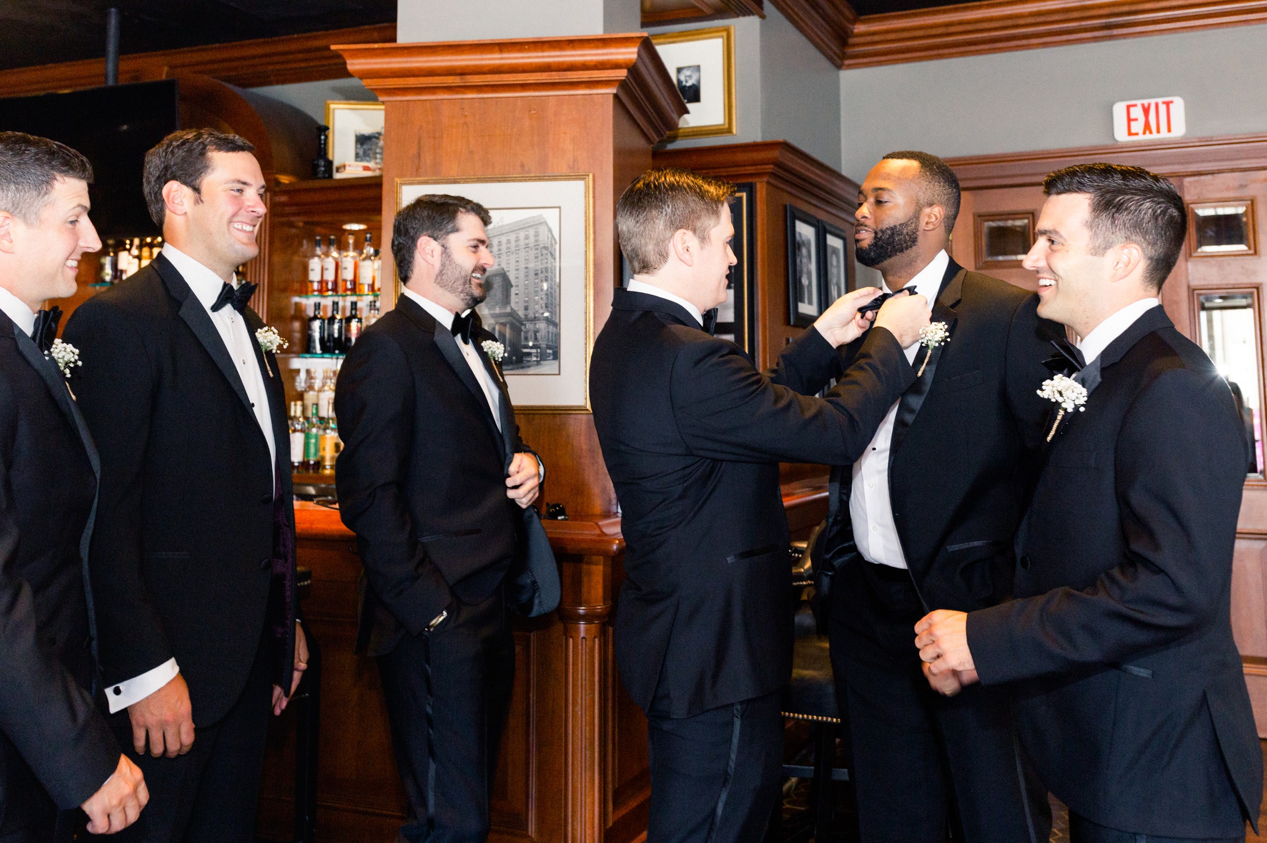Omni Parker House Wedding Getting Ready Boston Wedding groom puts on finishing touches with groomsmen
