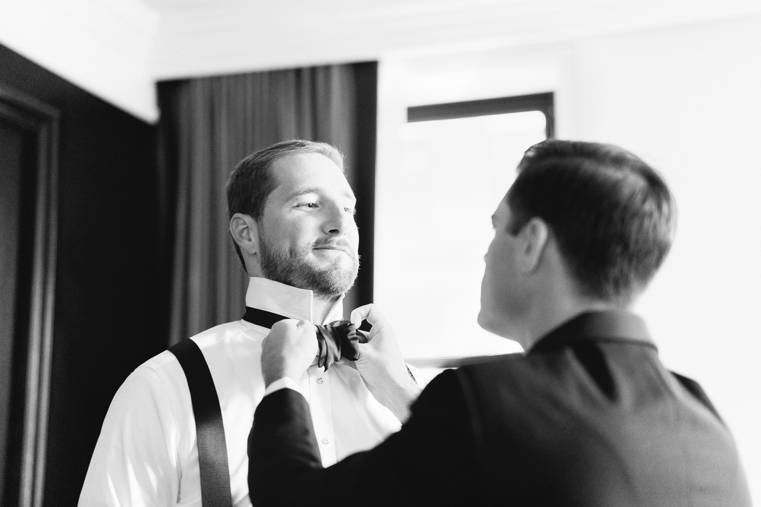 Boston groom getting ready at Beacon XV hotel for wedding in black and white