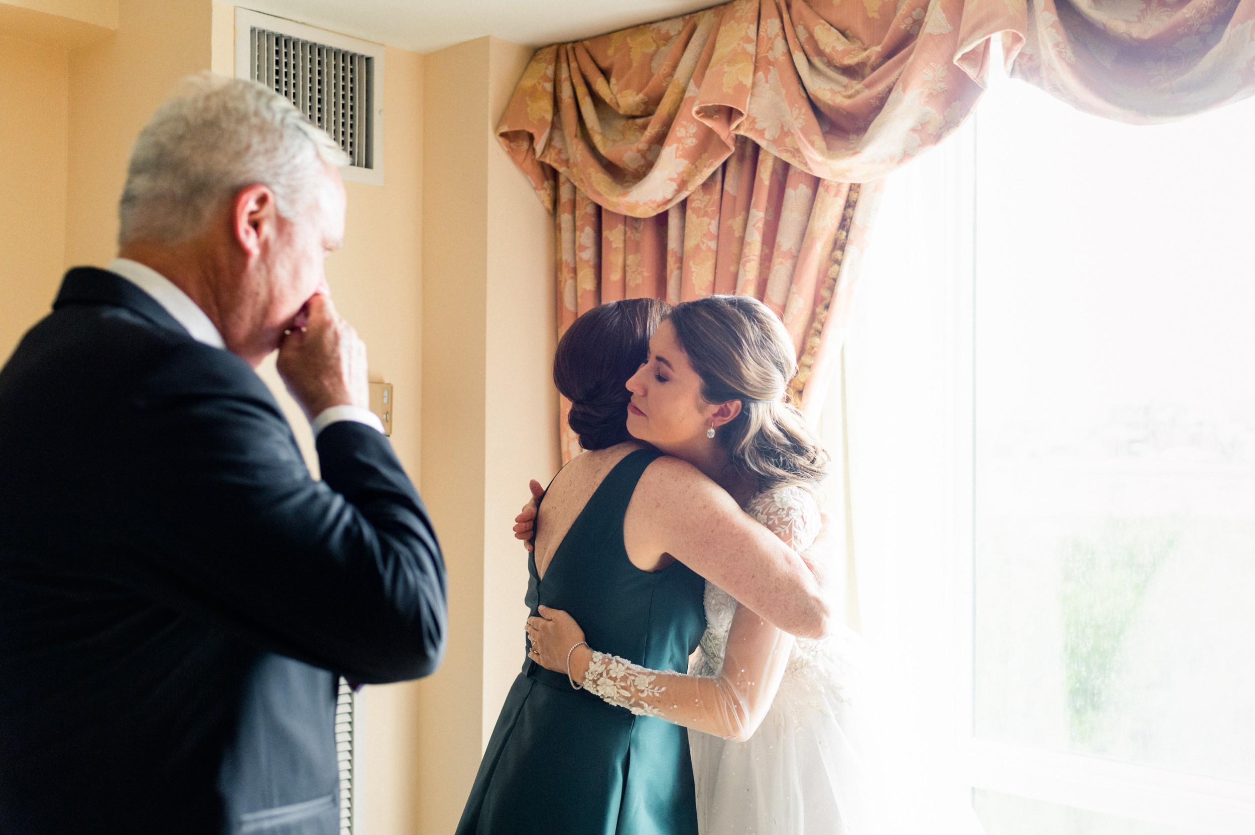 bride hugs her parents while getting ready for Boston wedding