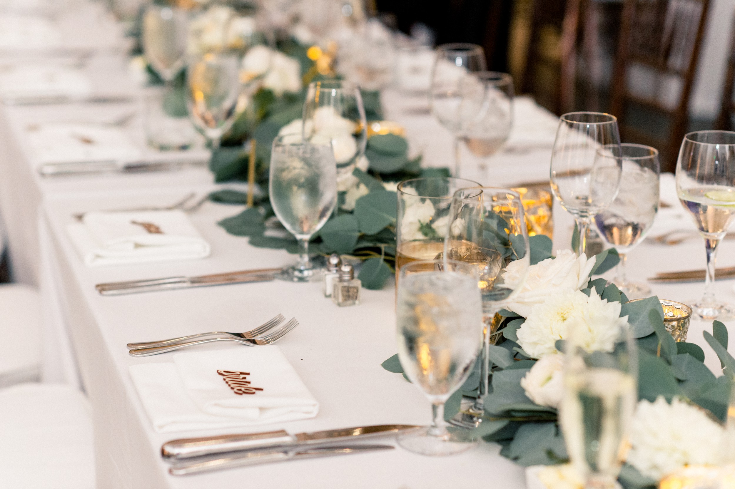 fall florals, candles, and gold table numbers for a black tie Boston wedding at harvard art museum