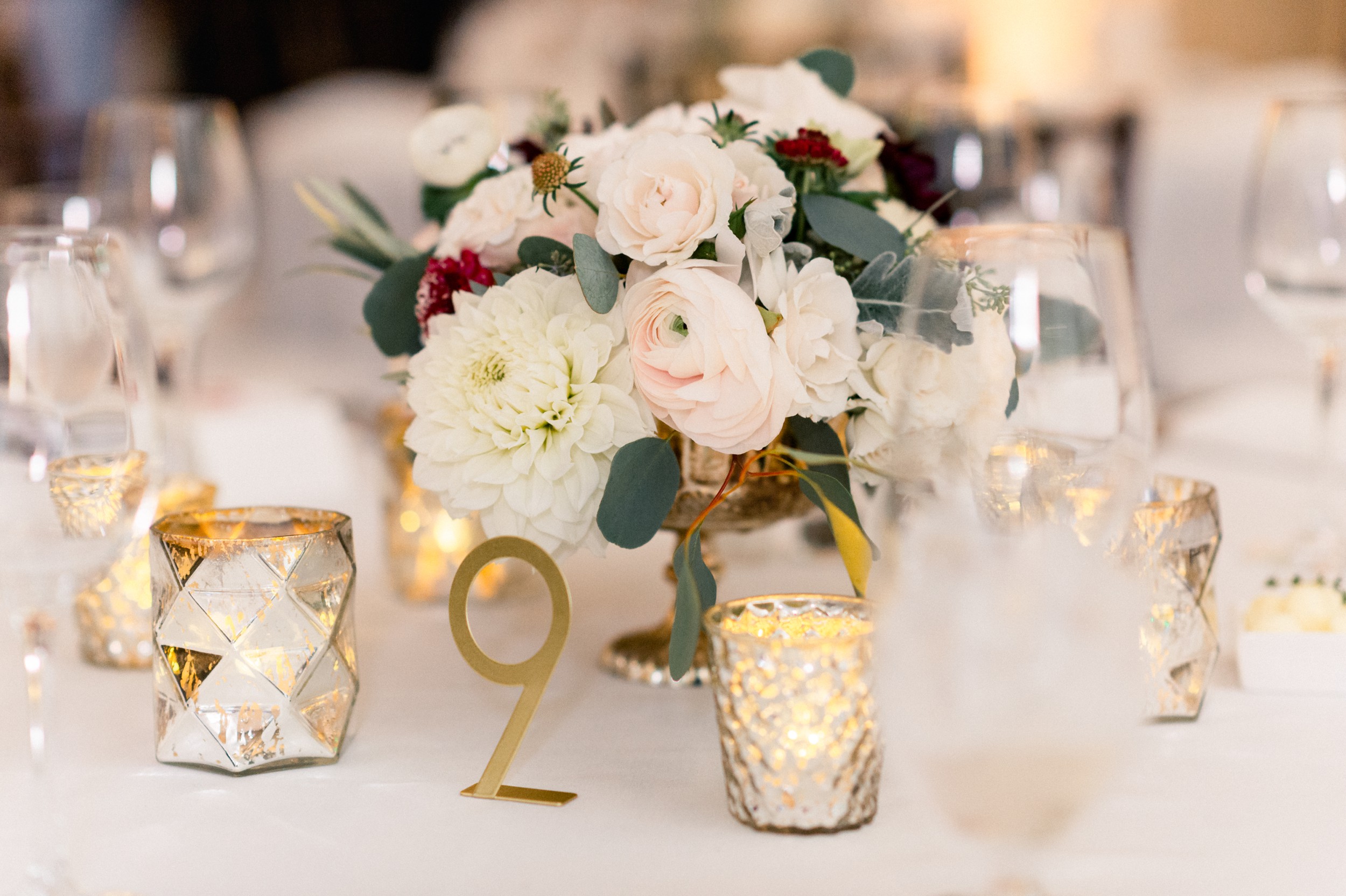 fall florals, candles, and gold table numbers for a black tie Boston wedding at harvard art museum