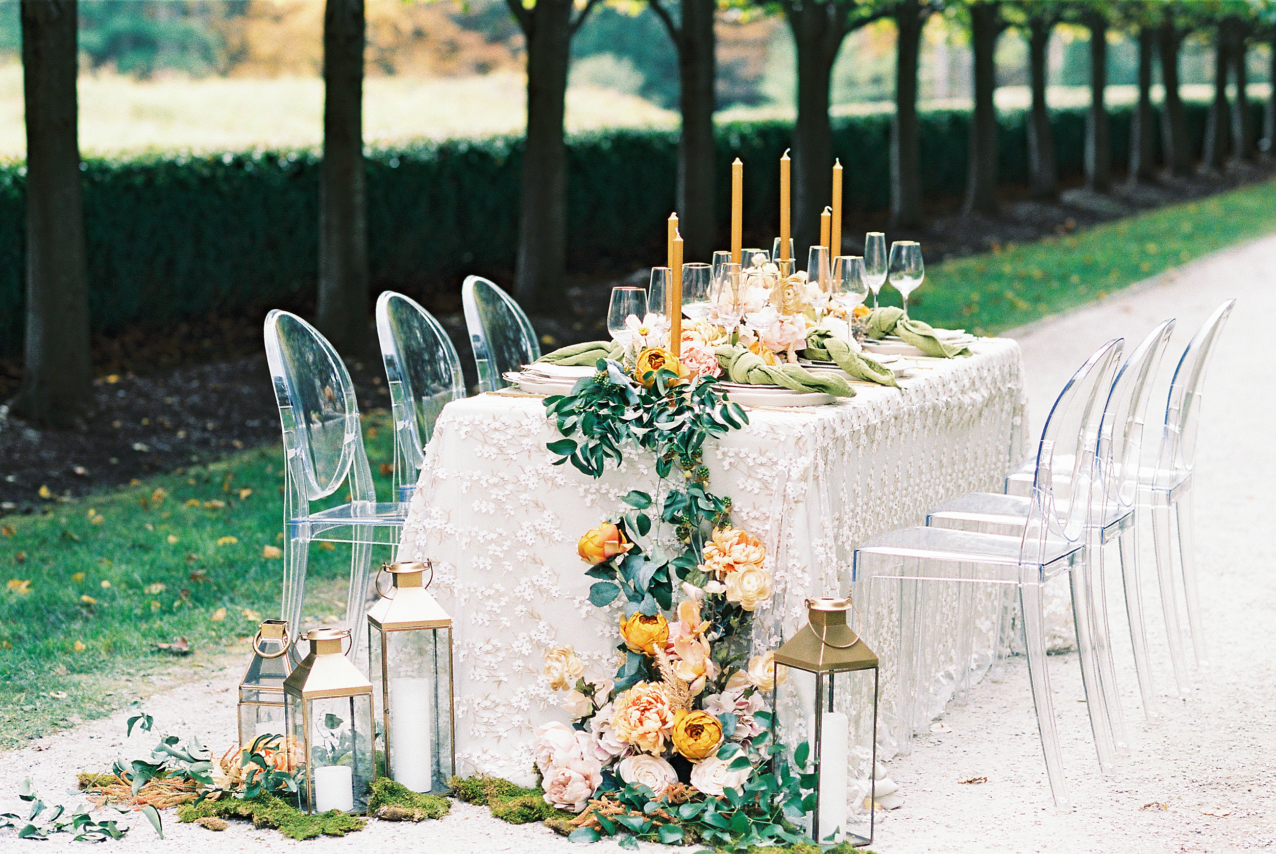 Wedding inspiration at The Mount in Lenox MA with clear acrylic chairs, lace overlay, and lush tablescape