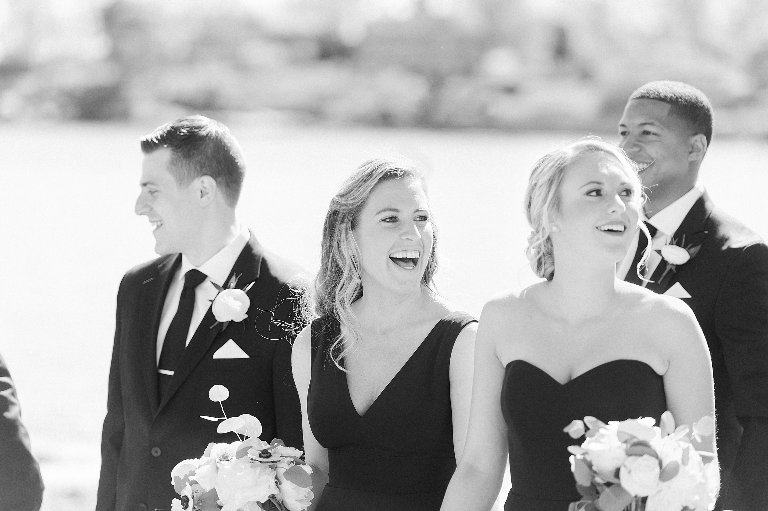 black and white photo of bridal party on the beach