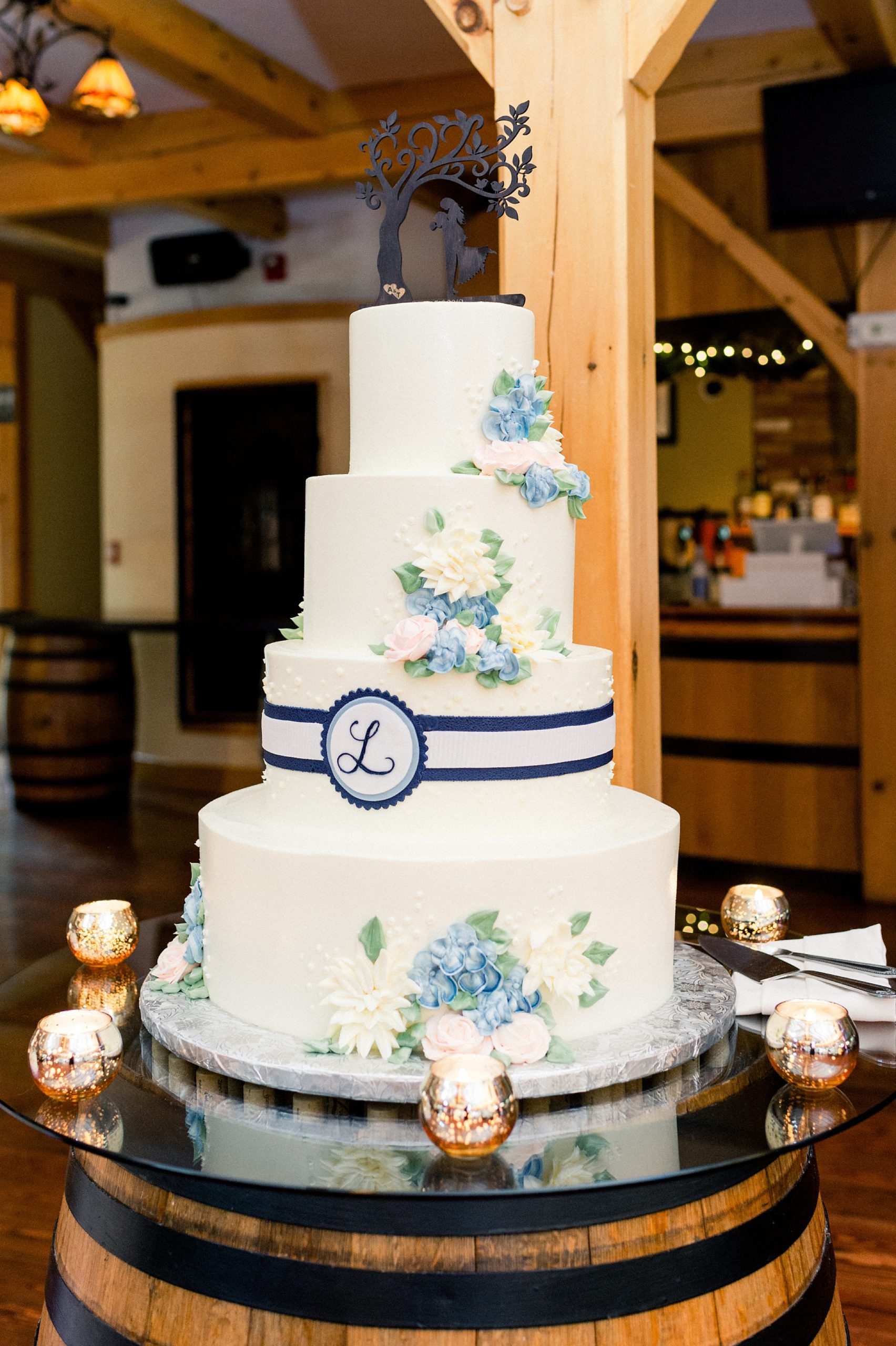 modern classic wedding cake with sugar flwers and white and navy band with monogram