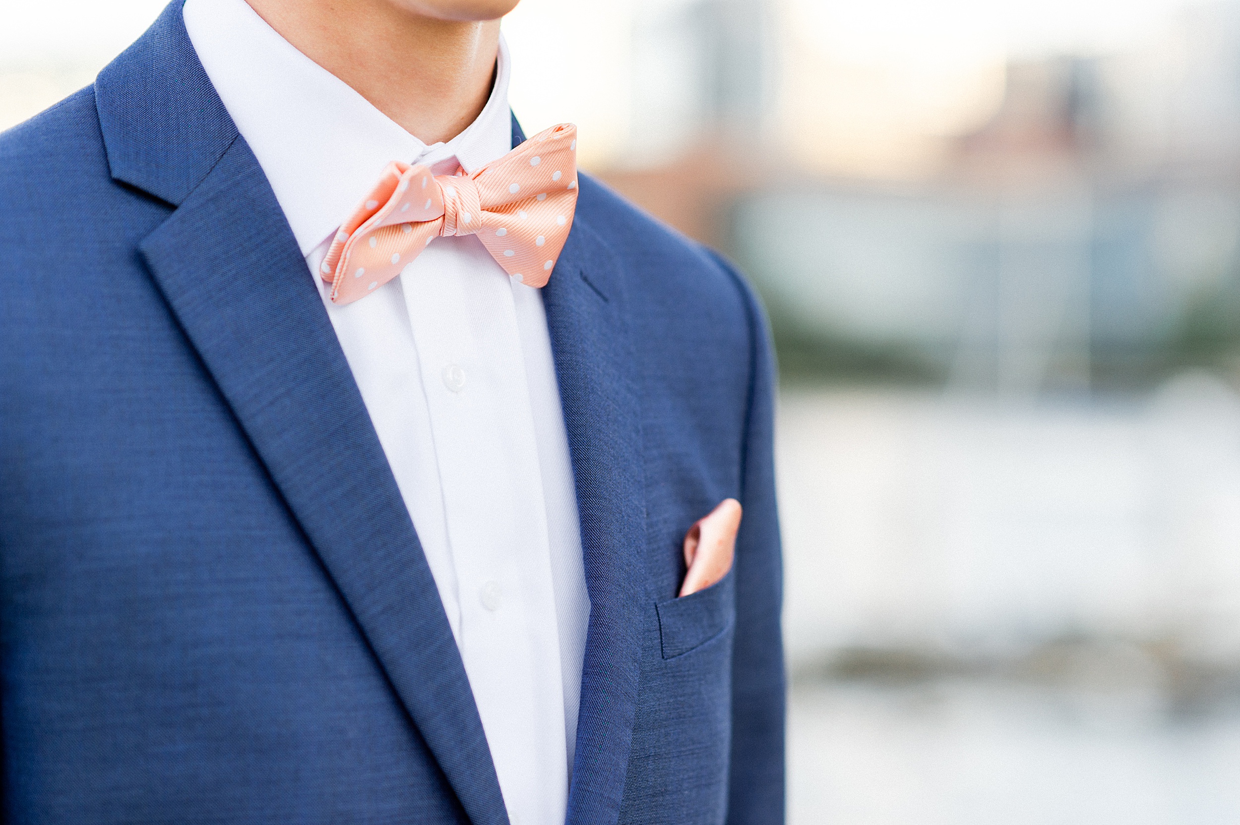 groom modern blue summer suit and coral bowtie