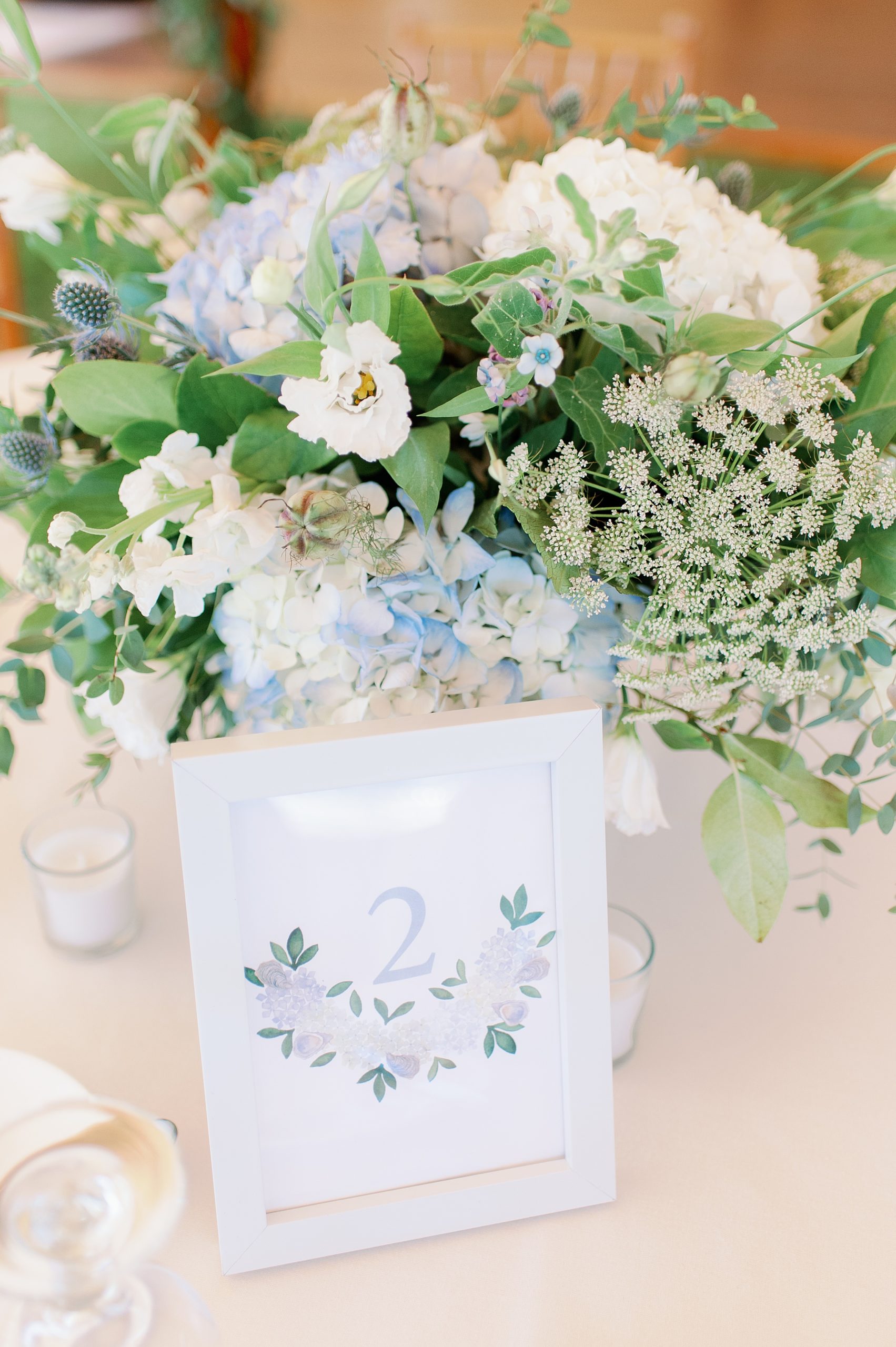 watercolor table numbers and floral centerpieces for tented new england wedding