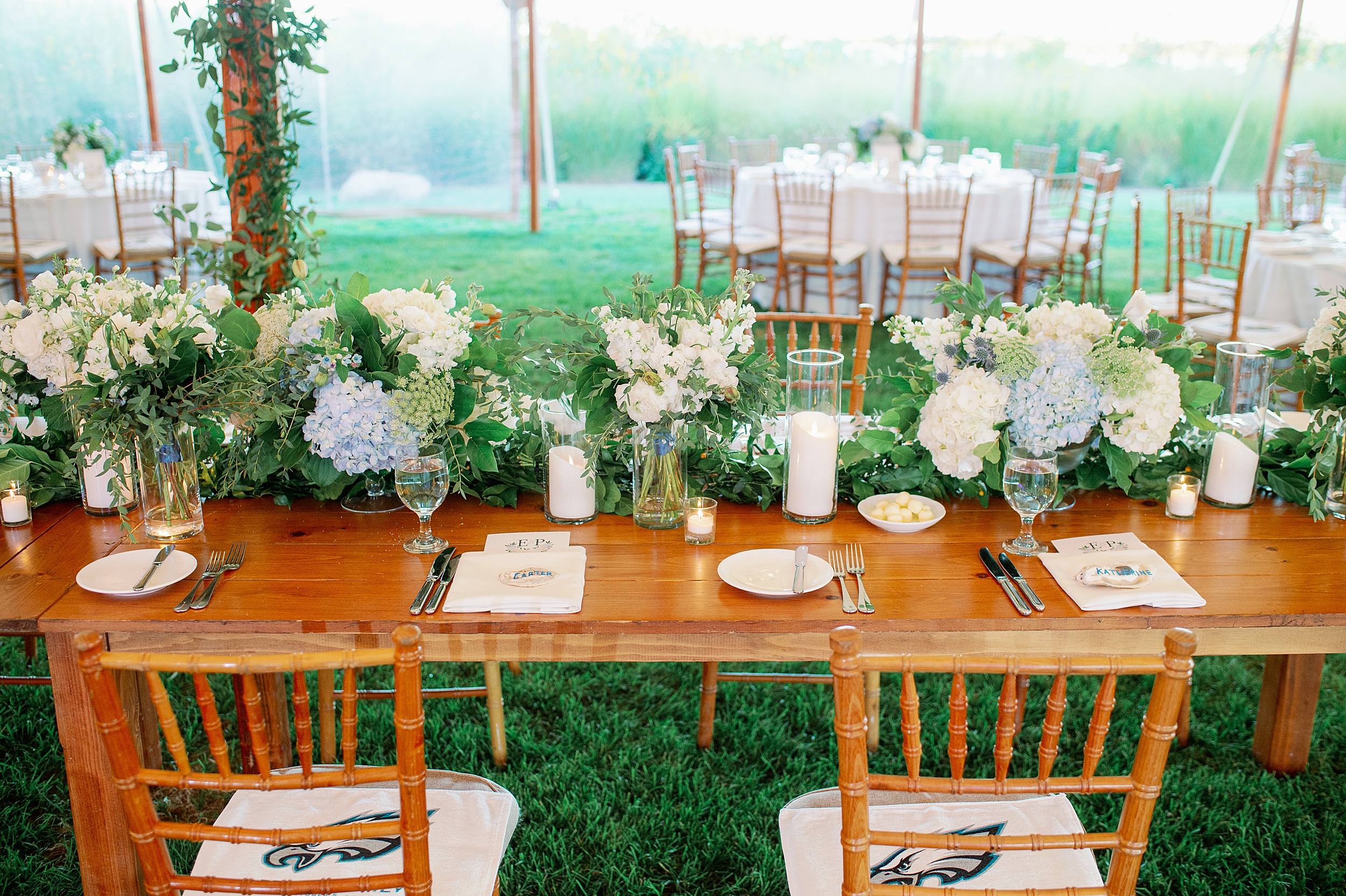 watercolor table numbers and floral centerpieces for tented new england wedding