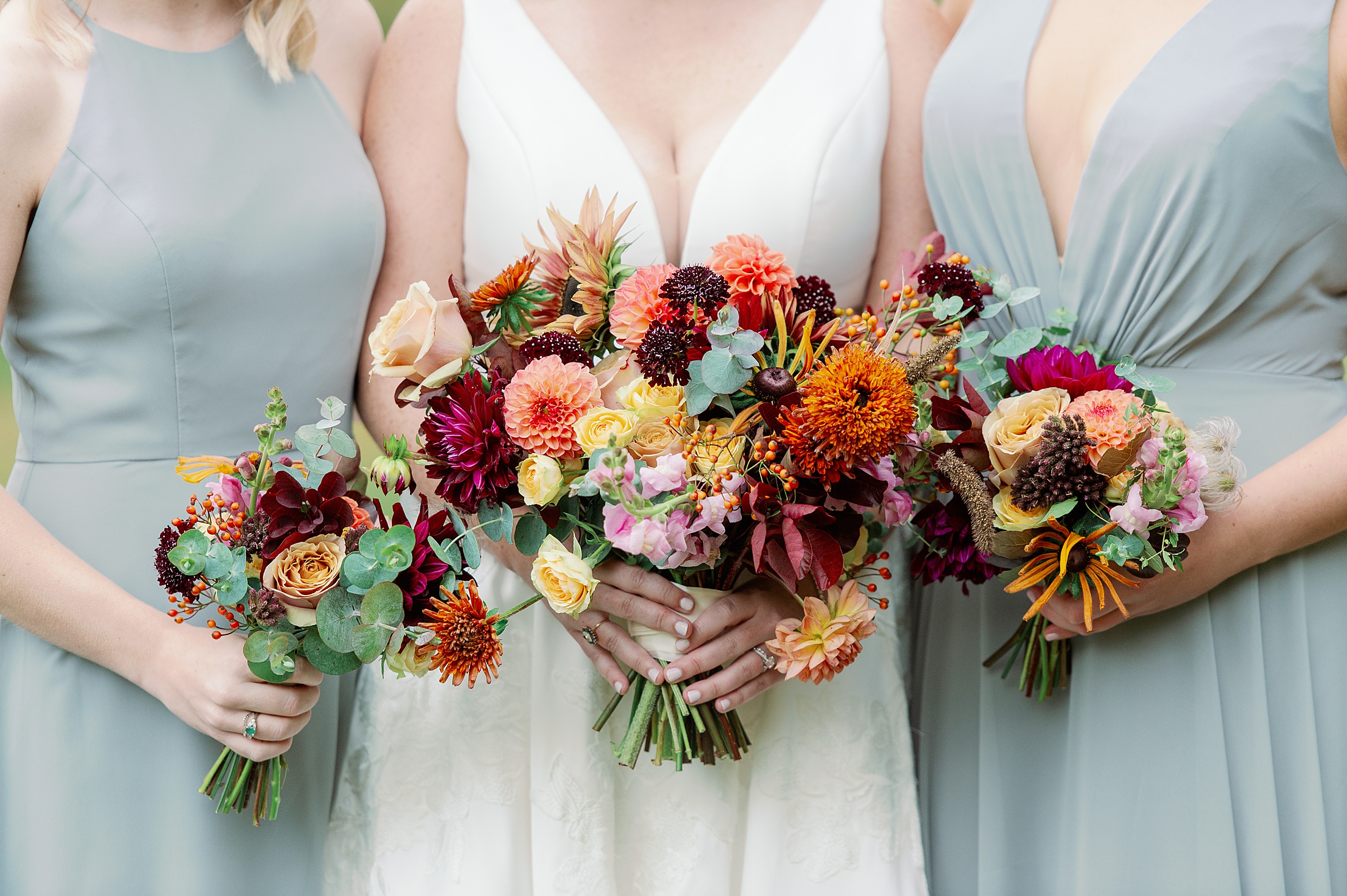 fall bouquets in orange cranberry and yellow with dove gray dresses