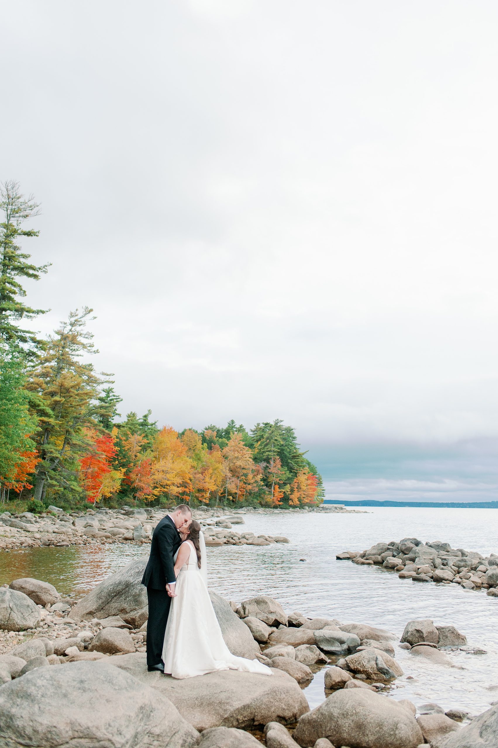 couples portraits on the rocks at Sebago Lake in Maine for The Stone Barn wedding