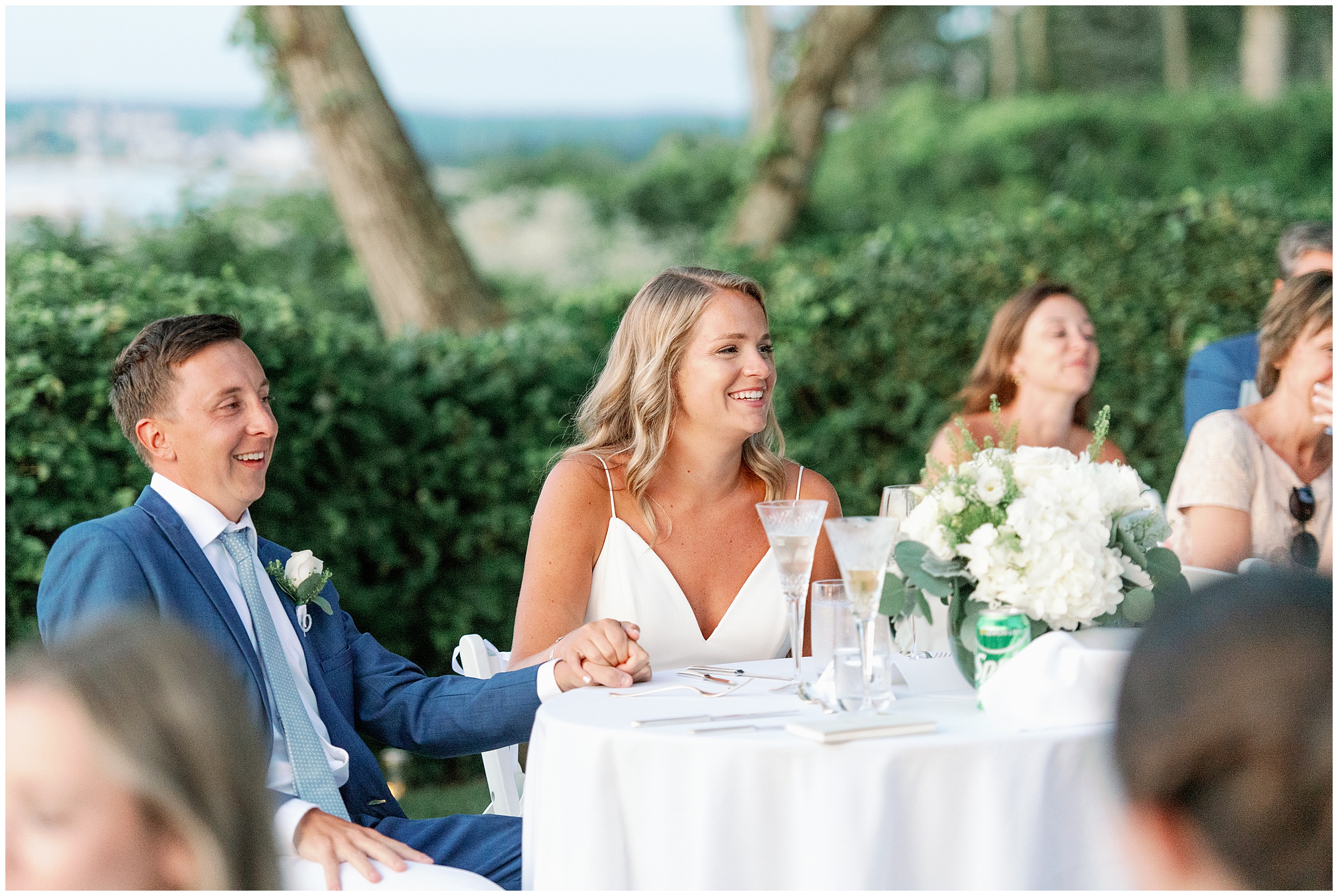 couple listens to toasts at al fresco micro wedding in cape cod