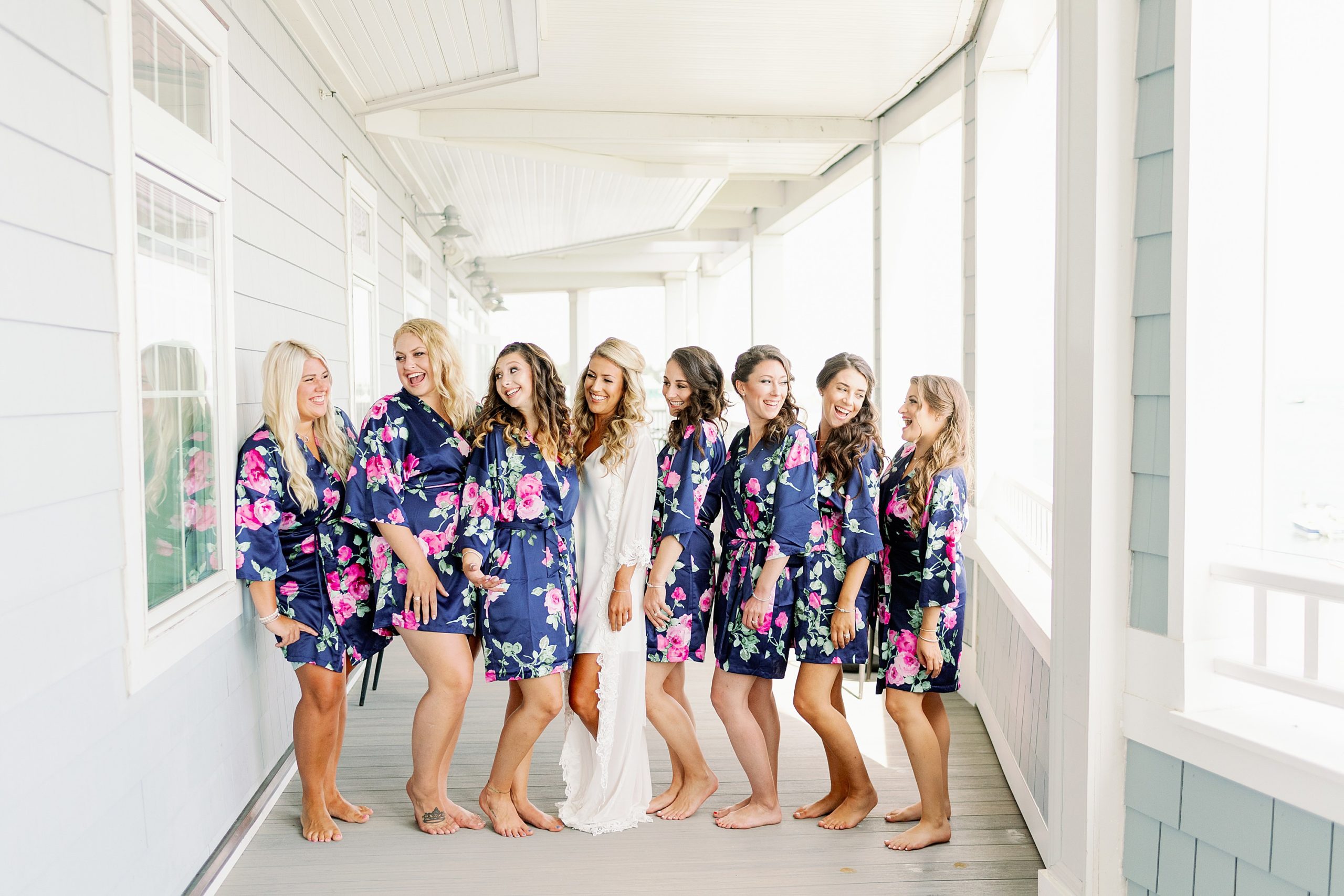 bride and bridesmaids in blue flower silk robes getting ready for wedding