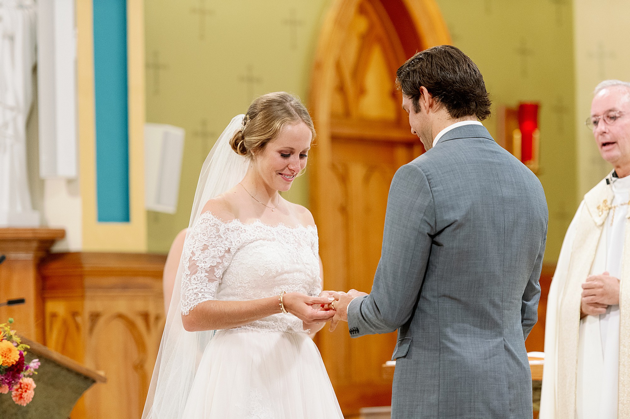 bride and groom exchange vows and rings at Lake Placid wedding ceremony