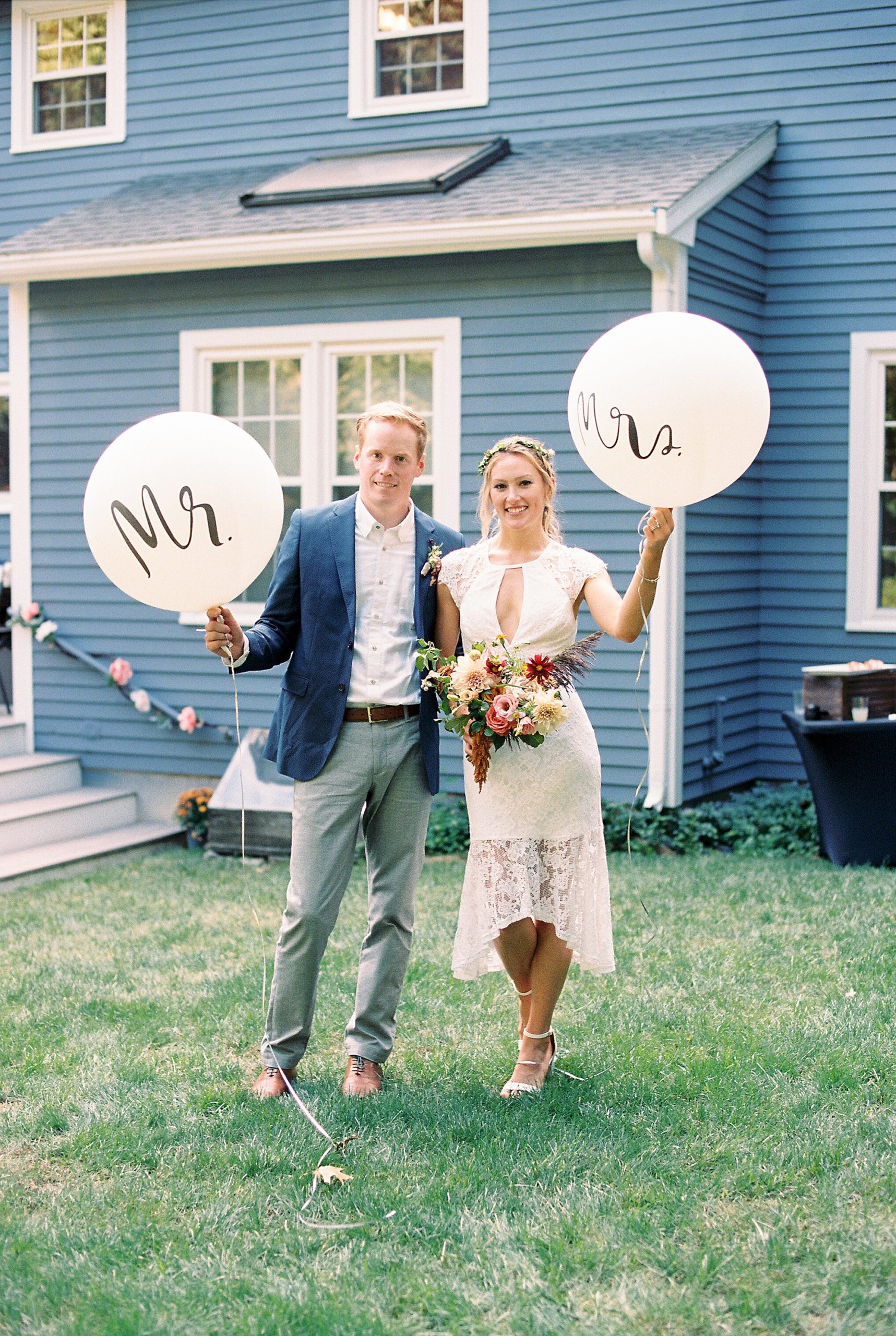 backyard micro wedding couples portraits holding mr and mrs balloons