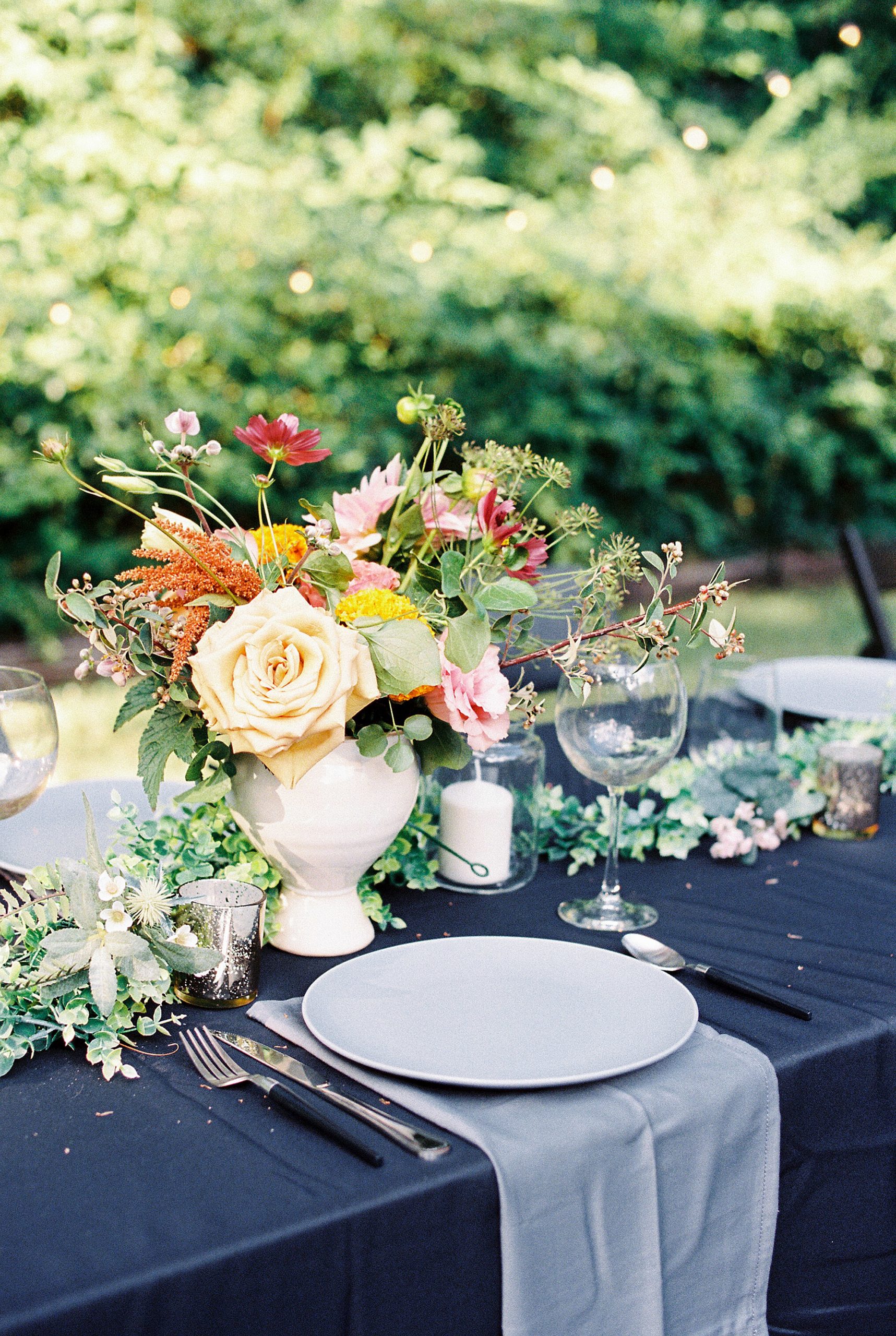 Floral centerpieces at al fresco table for backyard micro wedding