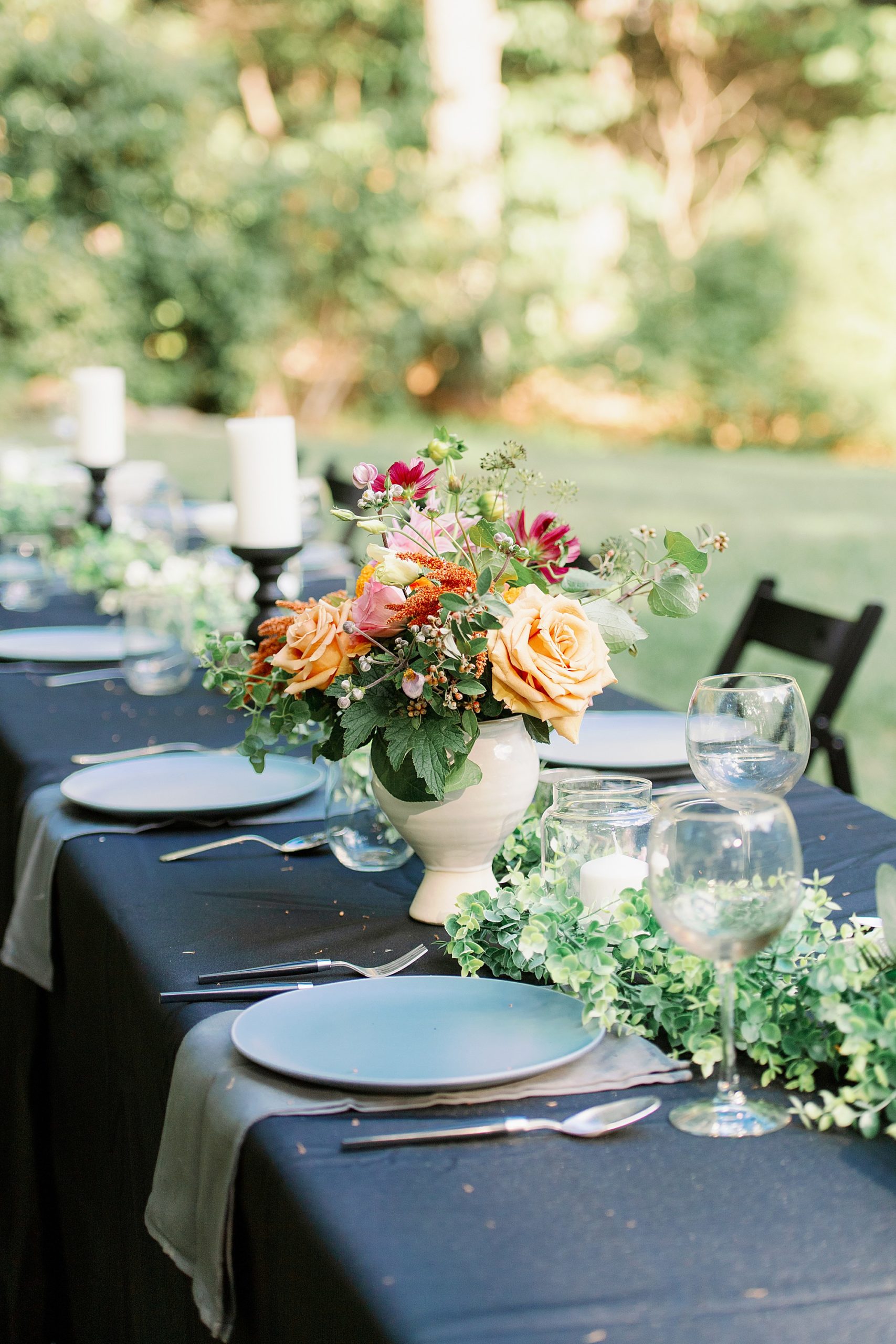 Floral centerpieces at al fresco table for backyard micro wedding