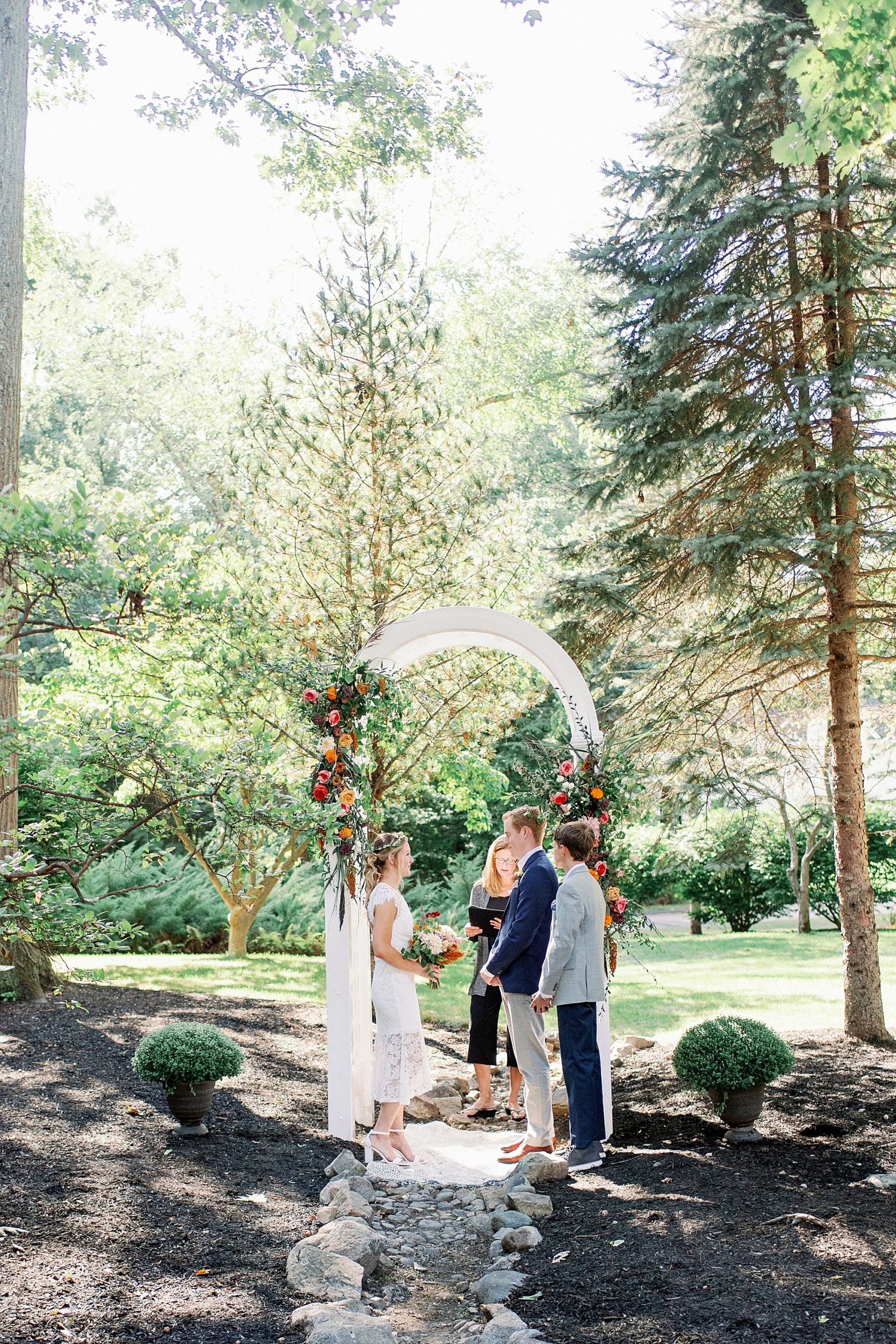 backyard micro wedding ceremony with vibrant flowers in Massachusetts