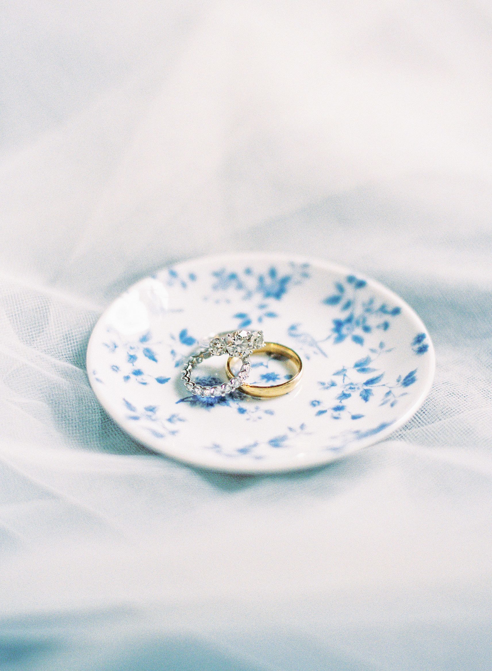 wedding bands and engagement ring styled on locust mat wedding flatlay