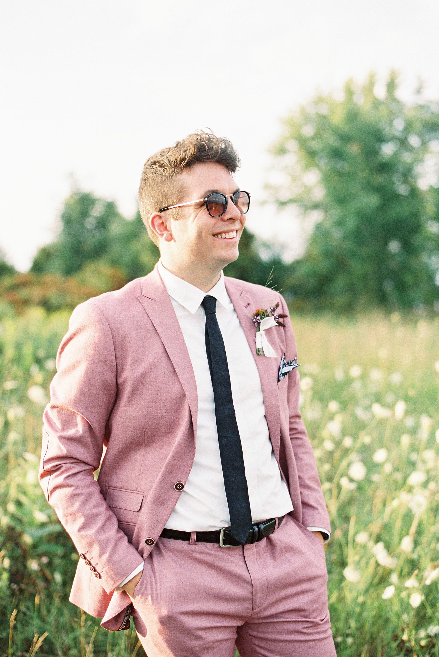 groom in salmon colored summer suit for Lake Placid Wedding