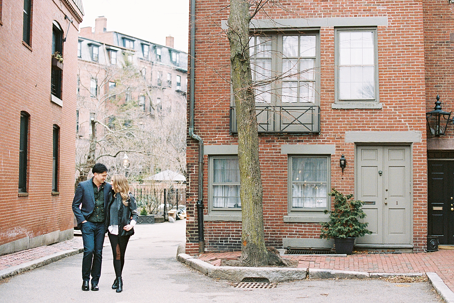 couple walks down street for Boston Winter Engagement Session