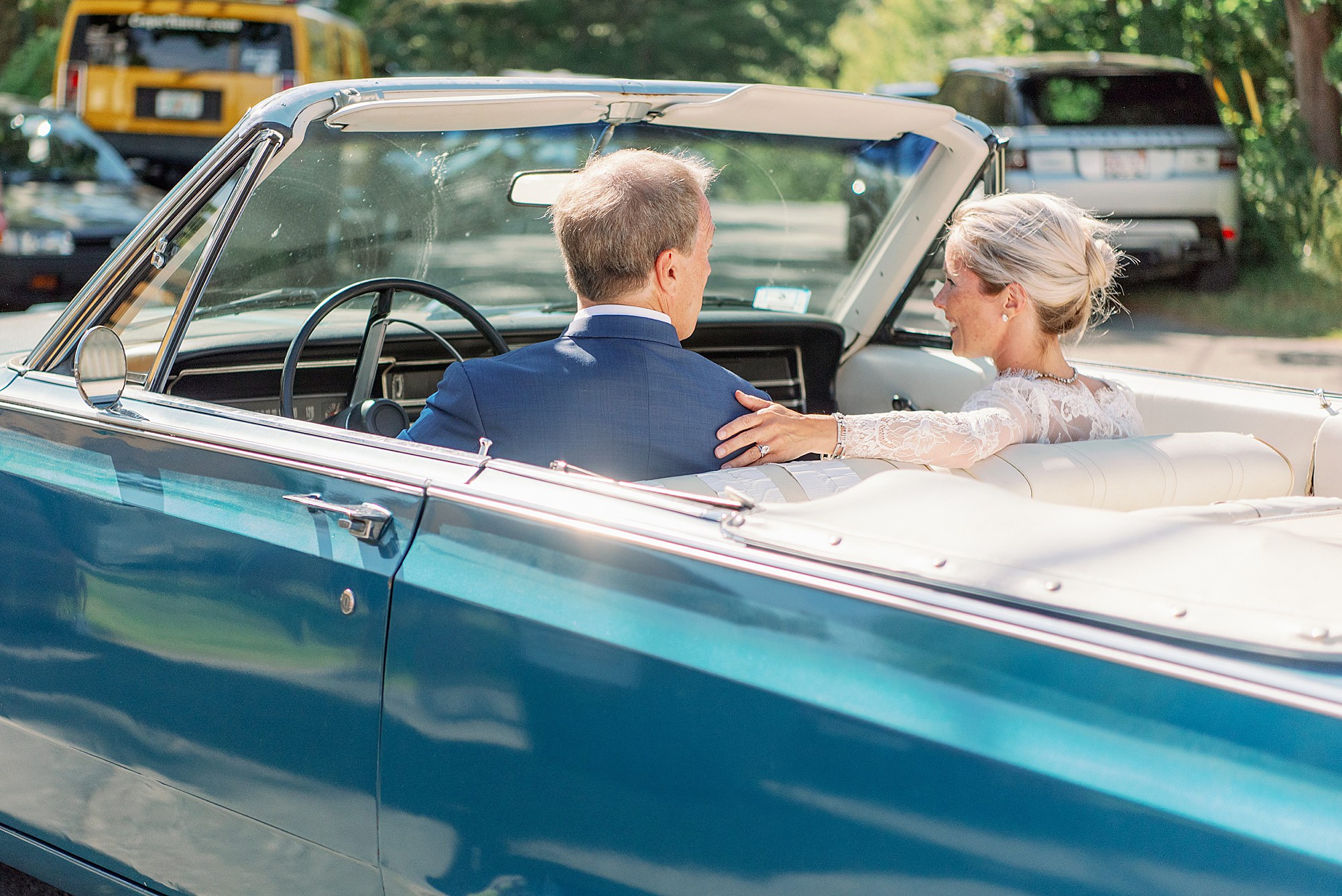 blue convertible getaway car with bride and groom after ceremony