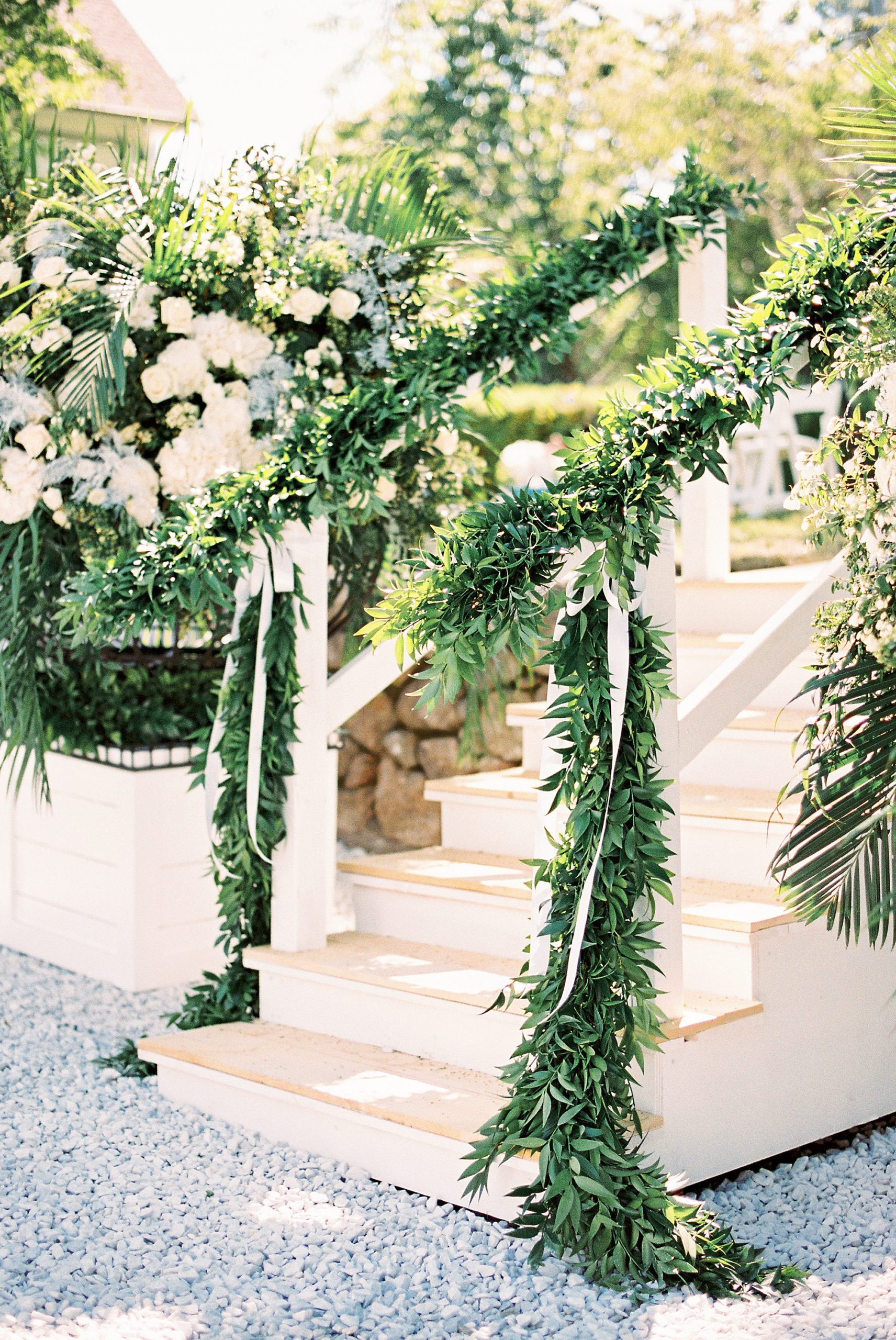 lush greenery on staircase for outdoor wedding on Cape Cod