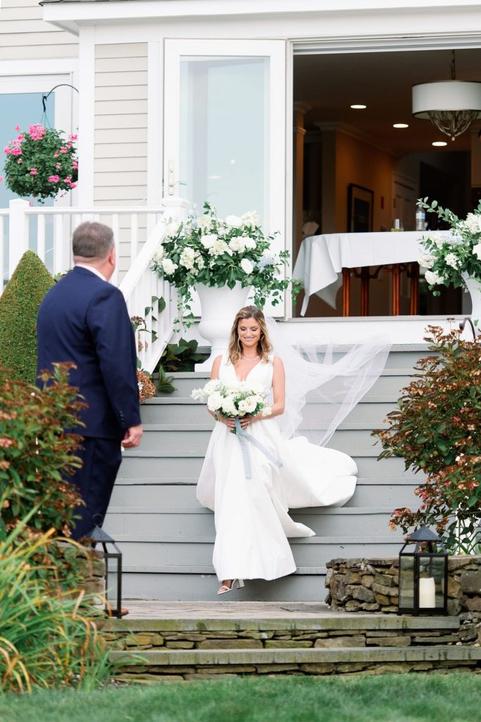 bride meets her dad to walk down the aisle at tented micro wedding 