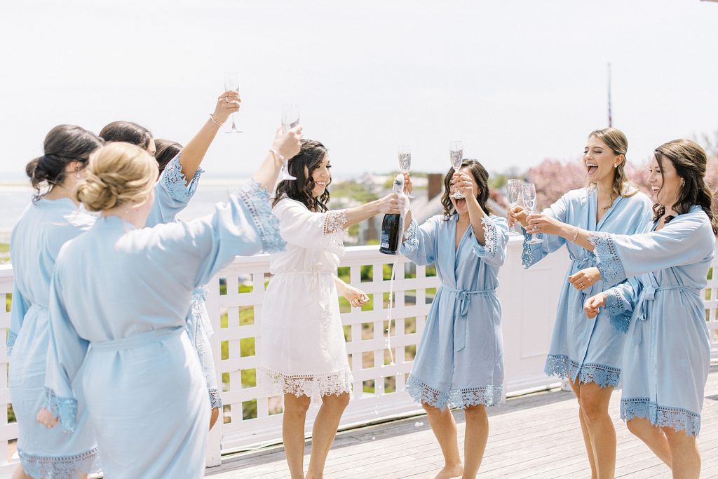 bride toasting in robes with bridesmaids at Chatham Bars Inn on Cape Cod