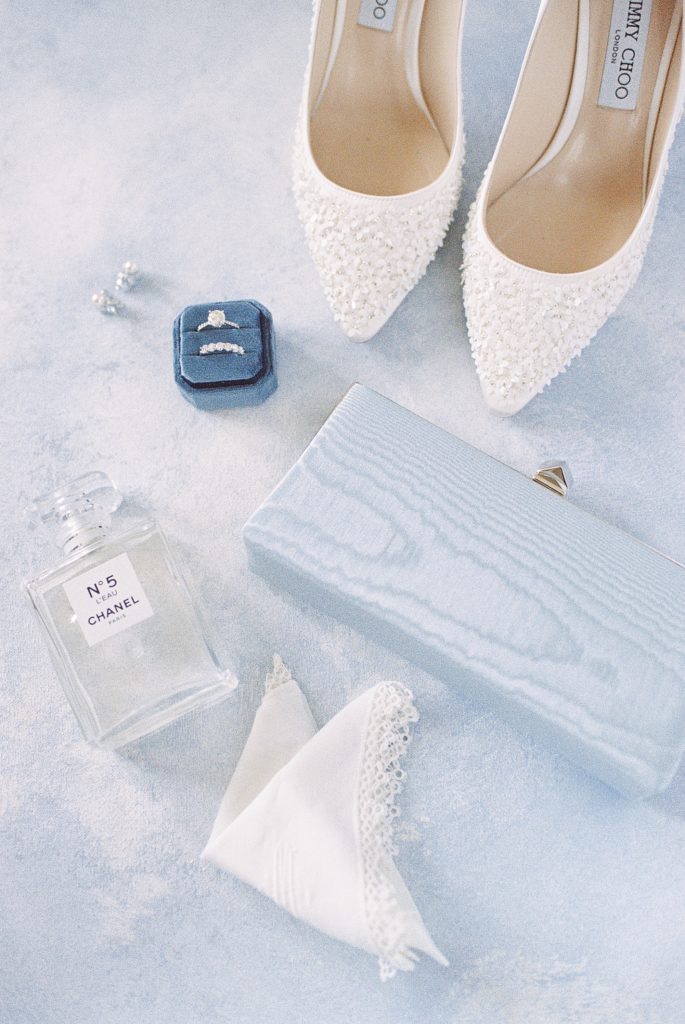 bridal details flat lay featuring jimmy choo shoes and chanel no 5
