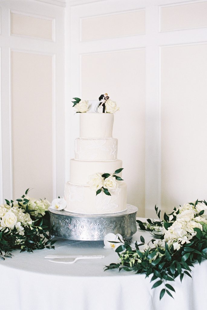 four tiered wedding cake with tone on tone decoration