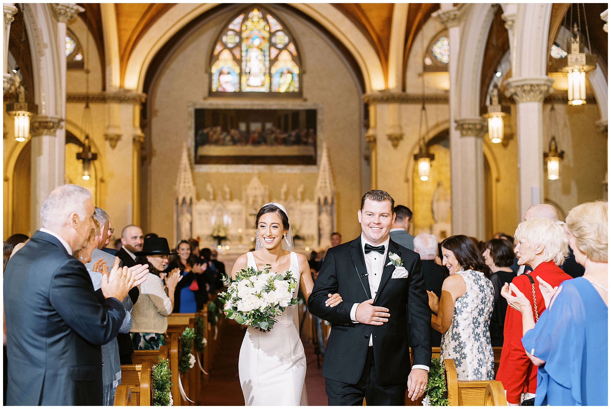 newlyweds walk down the aisle after church ceremony