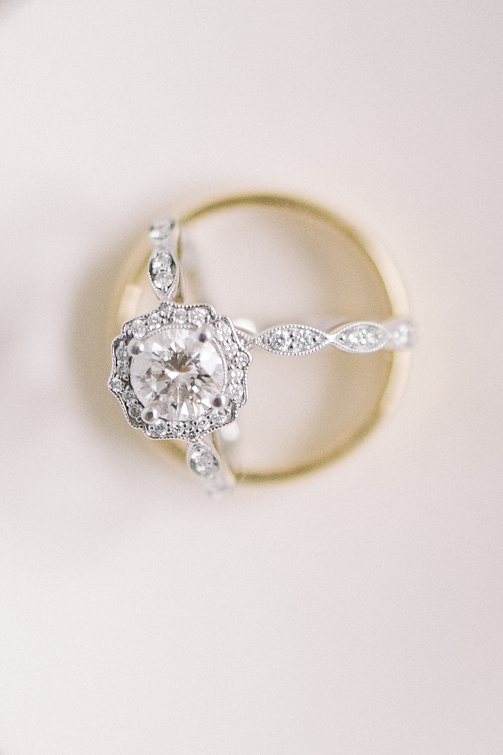 Up close image of brides rings nestled in groom's ring.