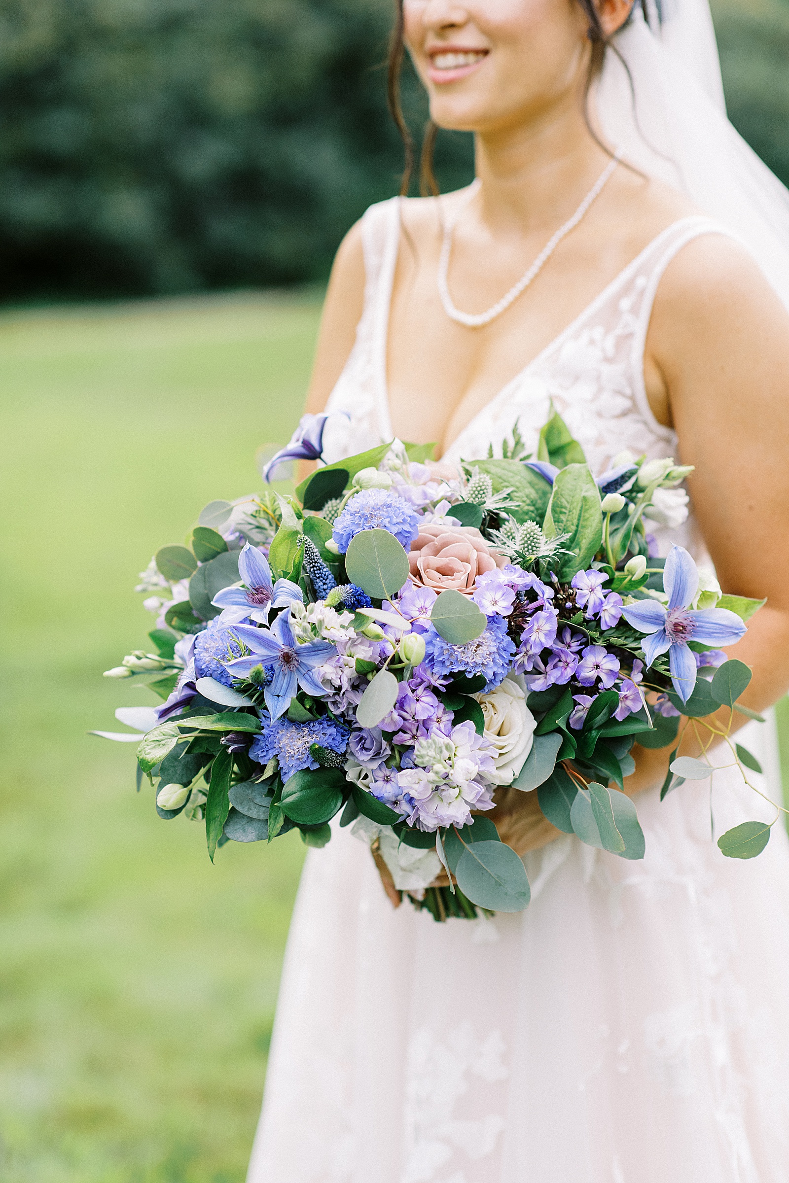 Up close of bridal bouquet with white and lavender flowers. 