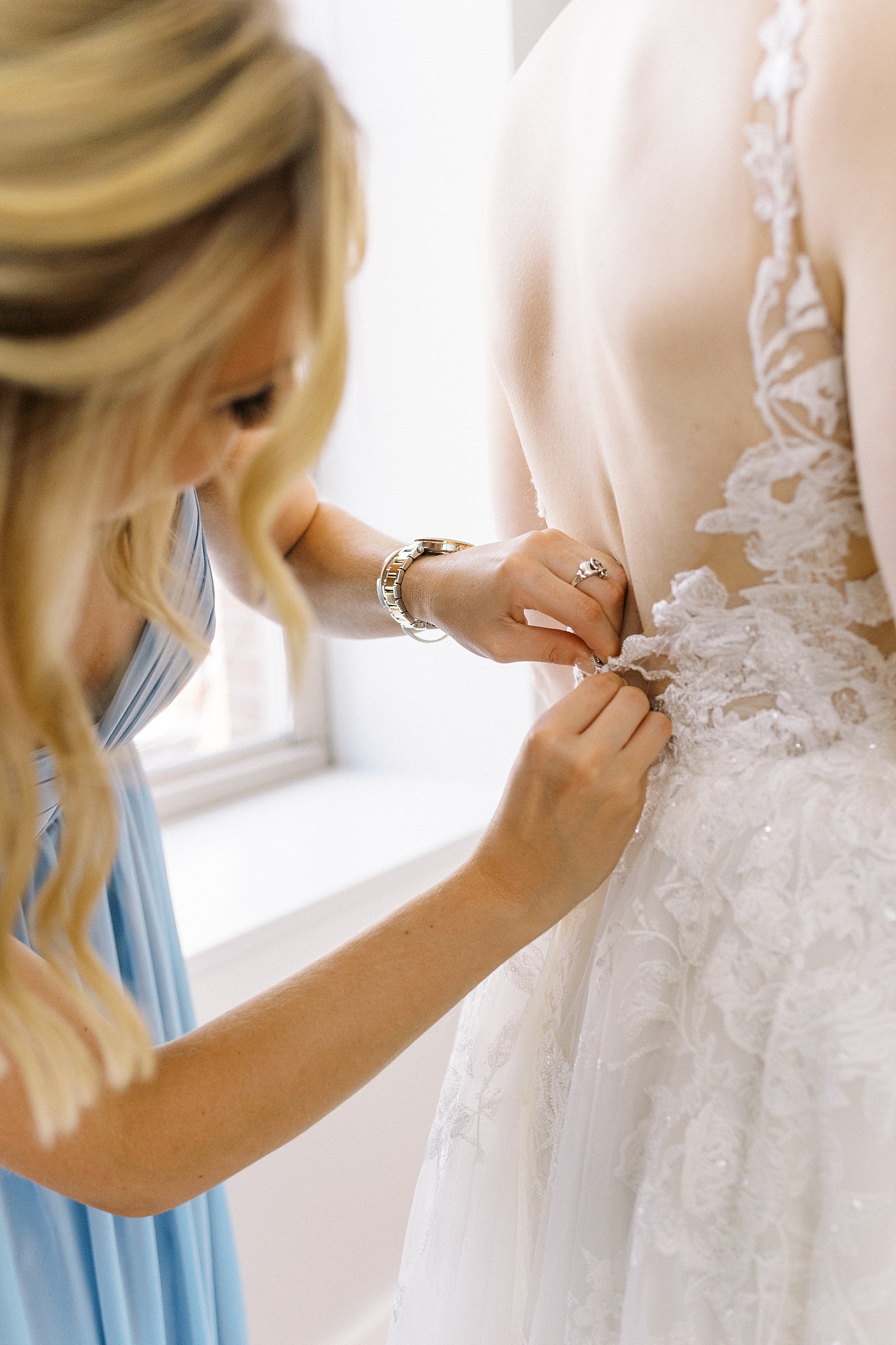 Wedding dress being zipped up at this Boston wedding by photographer Lynne Reznick. 