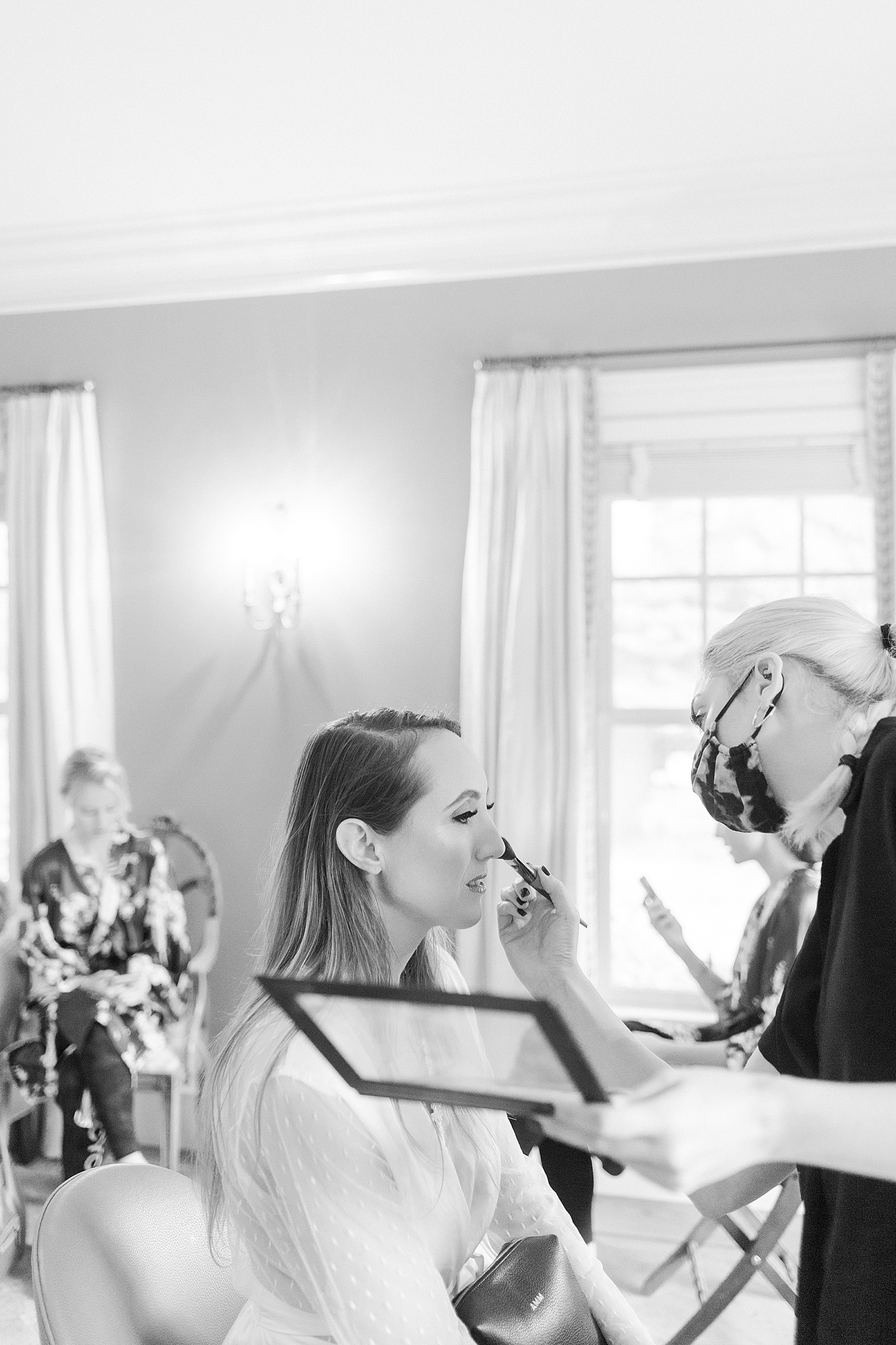 Bride getting her makeup put on before her wedding by New York Photographer, Lynne Reznick.