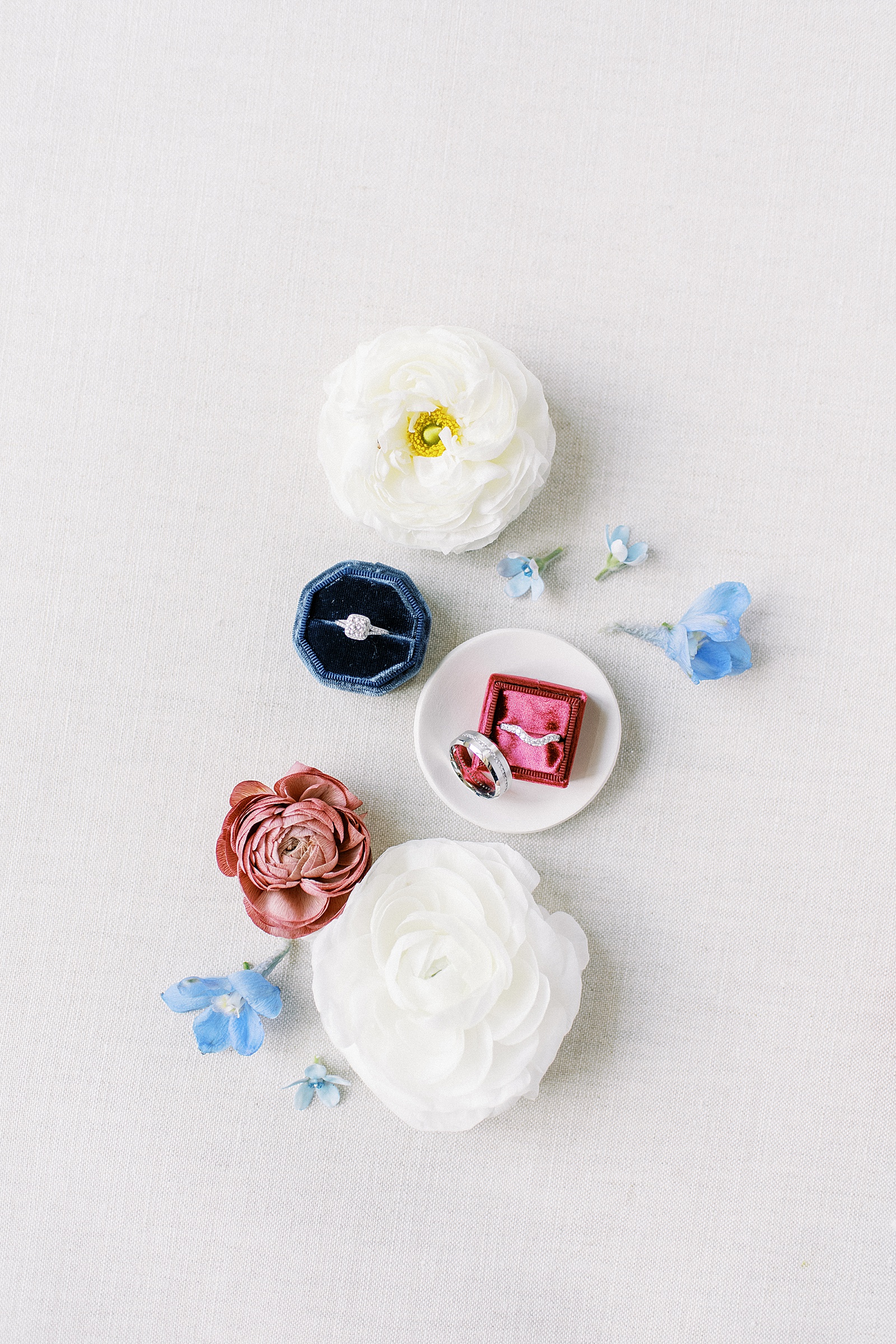 Two rings in velvet boxes surrounded by flowers for blog about efficiency strategies.