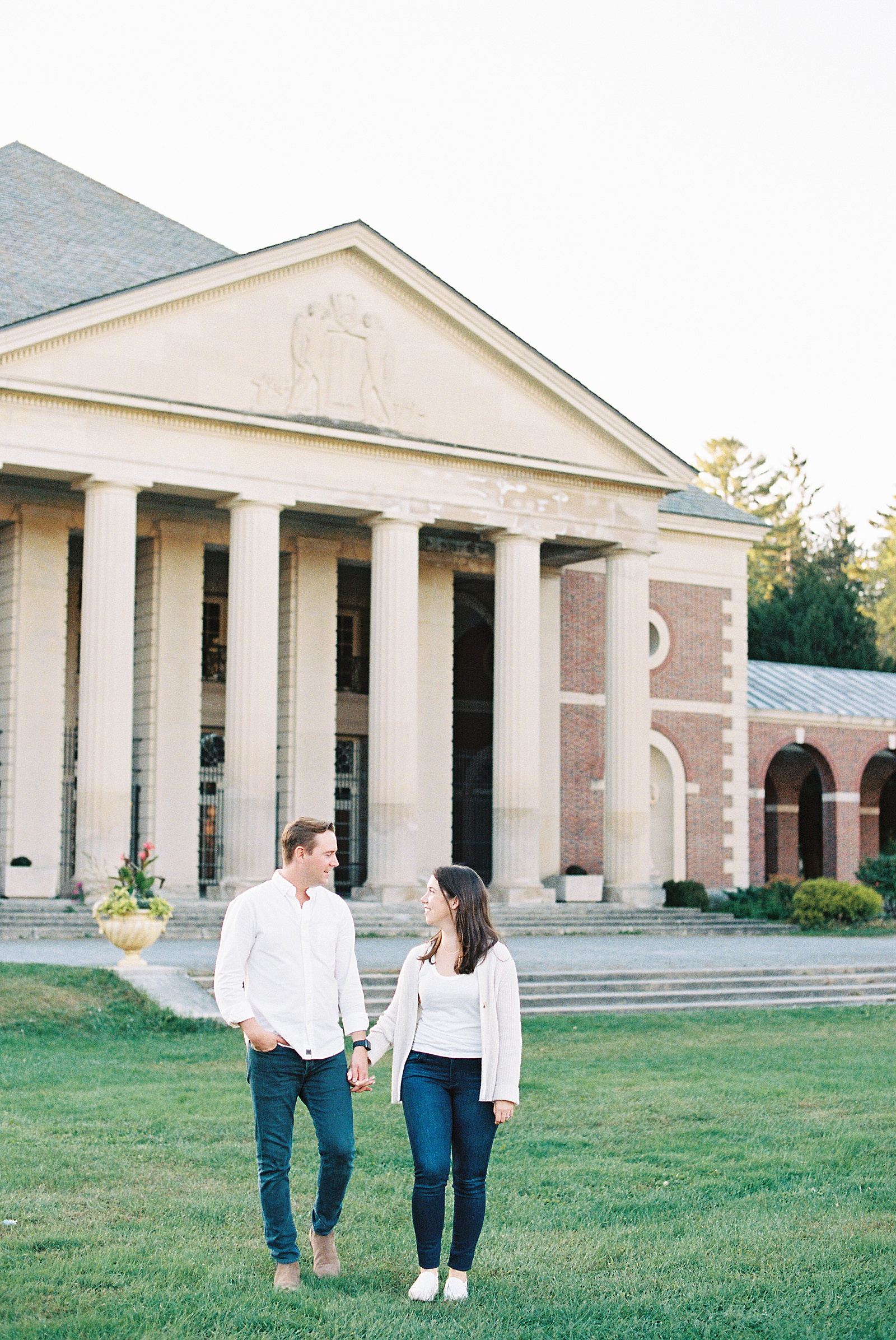 Couple walking in front of the Hall of Spring for their Saratoga Springs Engagement photo shoot
