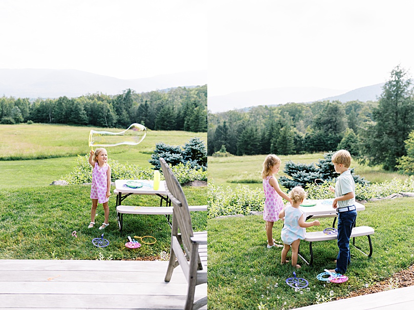 little kids play bubbles in New England field by Boston wedding photographer