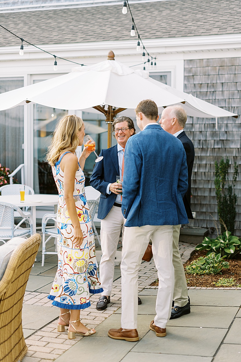 bride and groom talking with friends during rehearsal dinner photography event