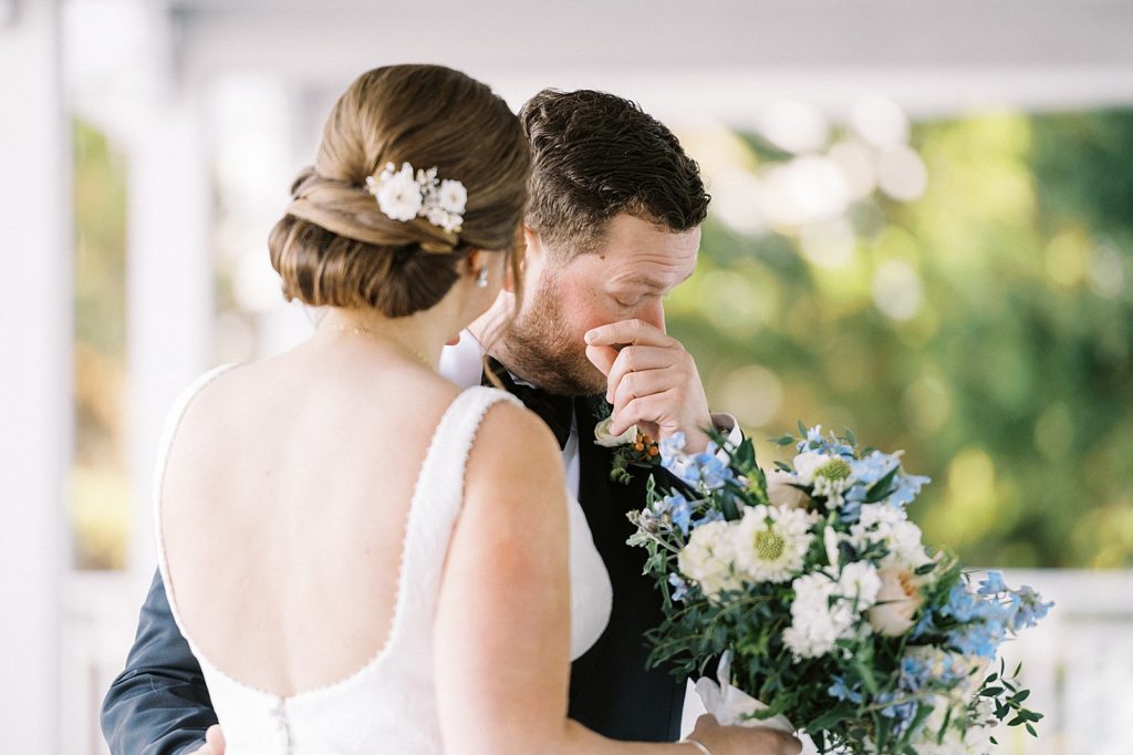 groom tearing up after seeing his bride at their first look in Cape Cod