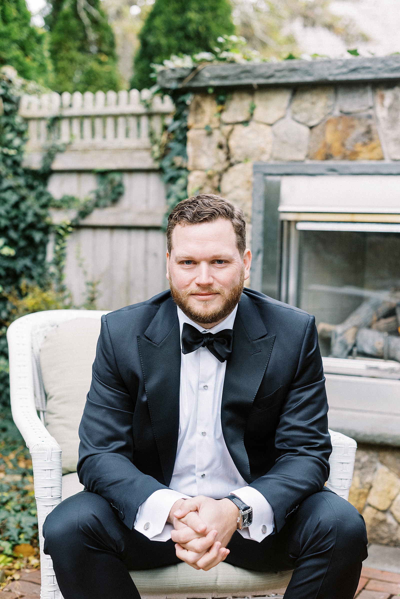 Groom in a chair on a patio by Cape Cod photographer Lynne Reznick