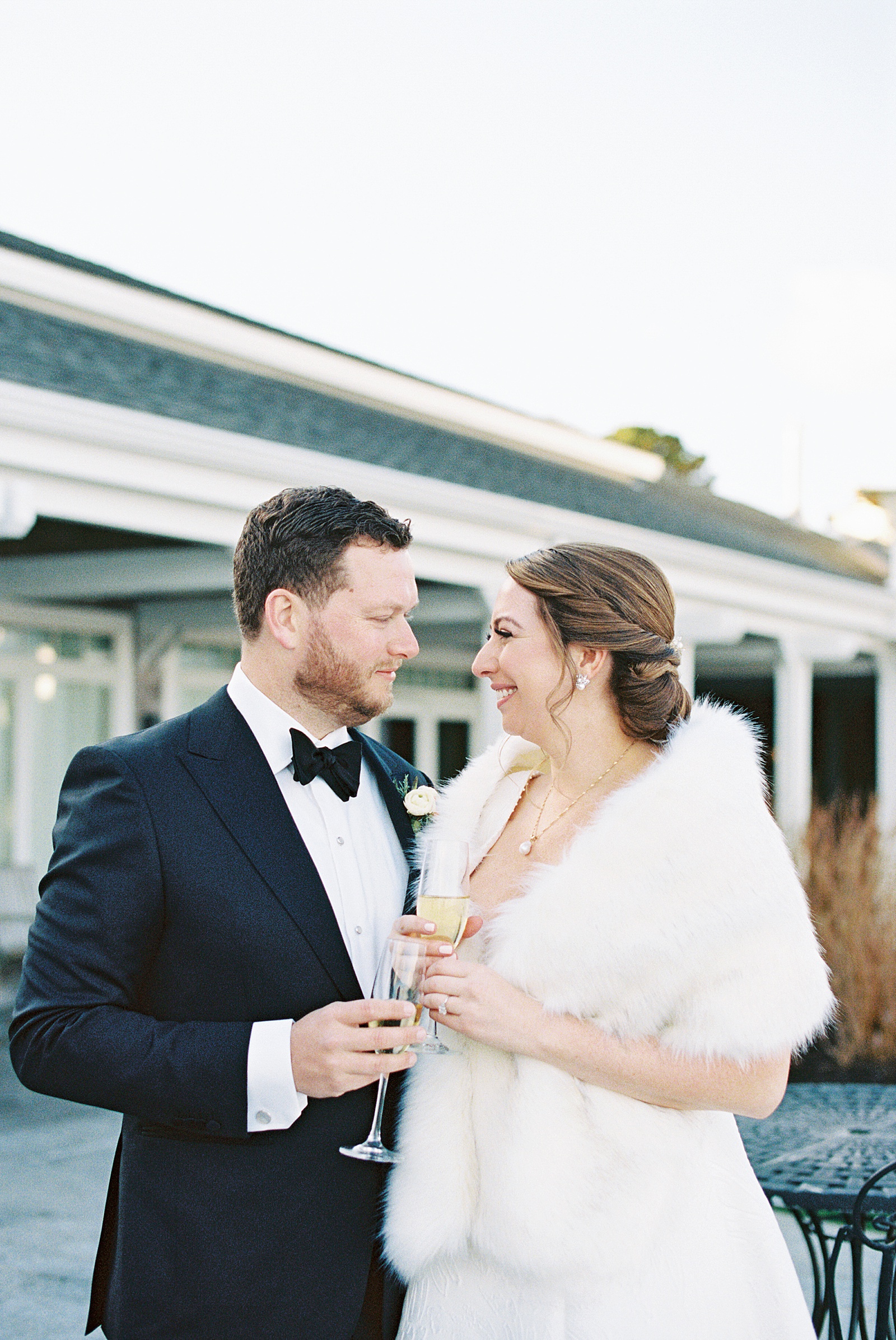 A bride and groom raising a toast before their ceremony 