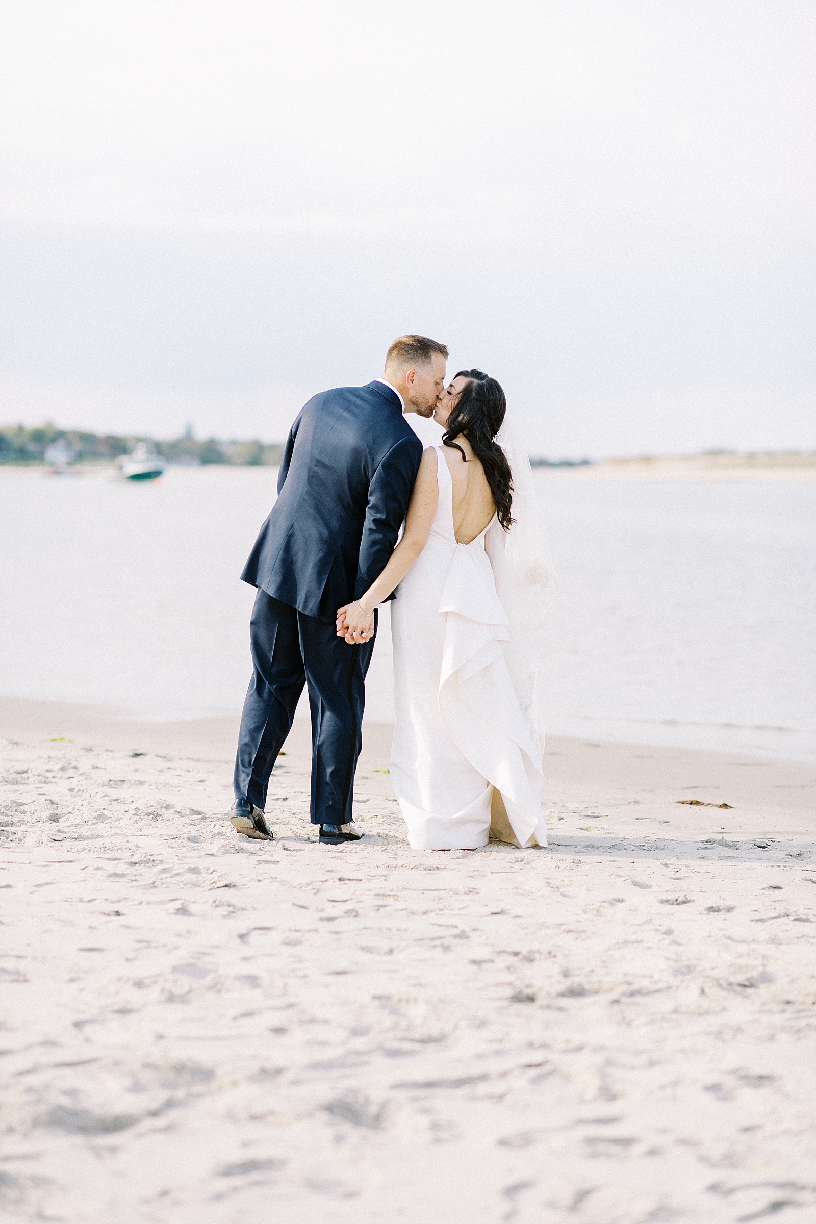 bride and groom kissing on the beach by New York Photographer with consistent editing style