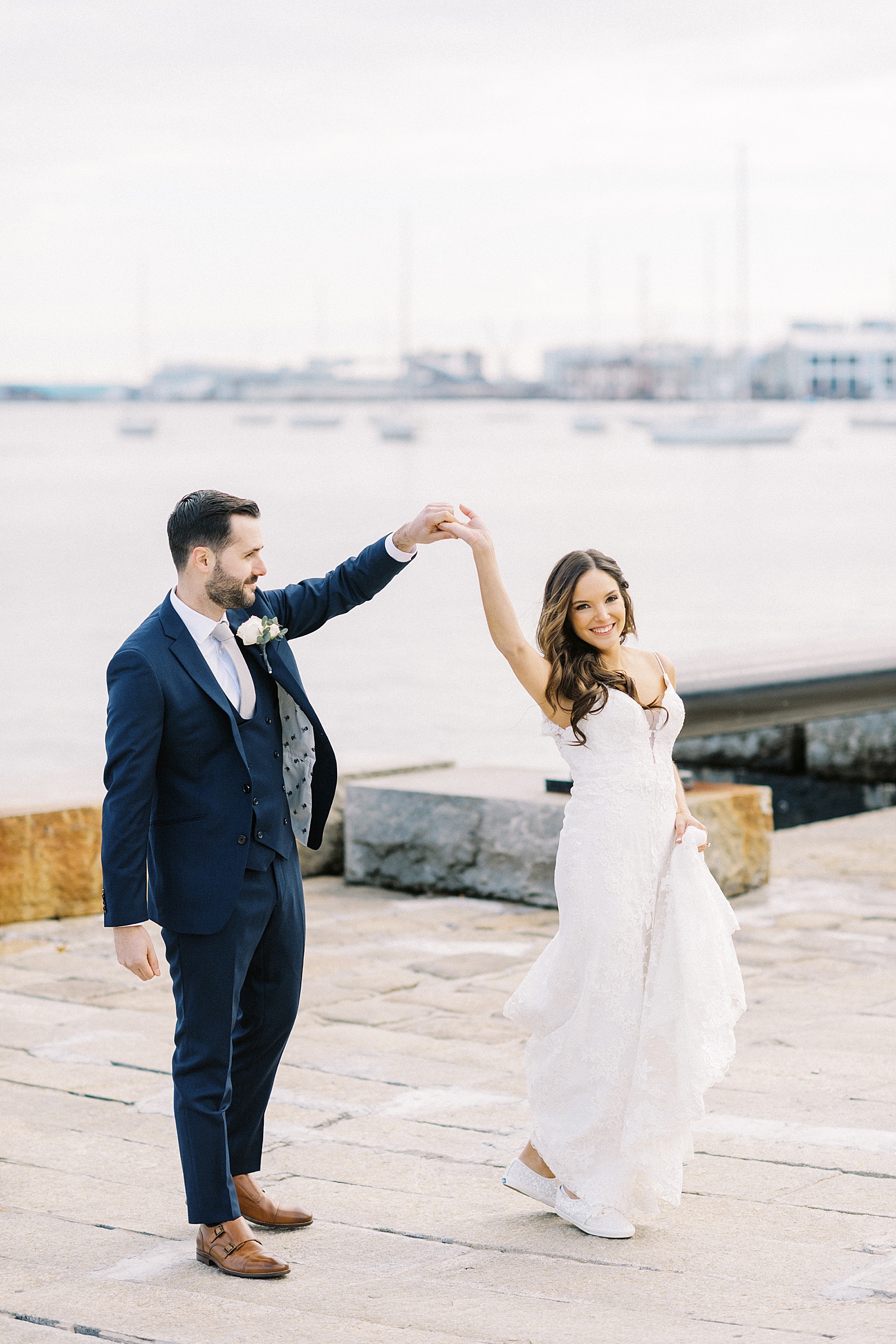 groom spinning bride by NY photographer Lynne Reznick with her consistent editing style